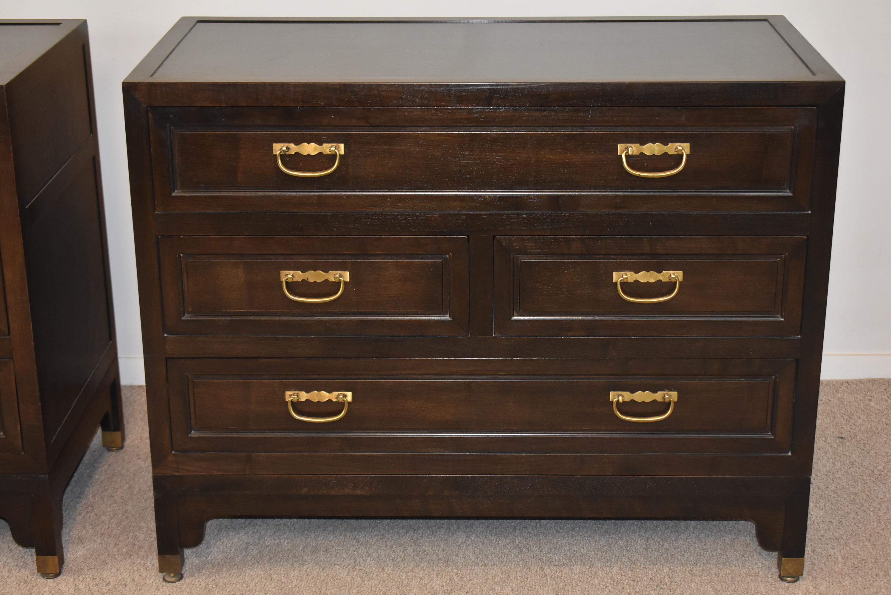 Pair of chest by Michael Taylor for Baker. This pair is from the Baker Far East Collection, with an ebonized oak finish. These pieces each have four drawers, the drawer units come off the bracketed base. Drawers have brass pulls. Excellent vintage