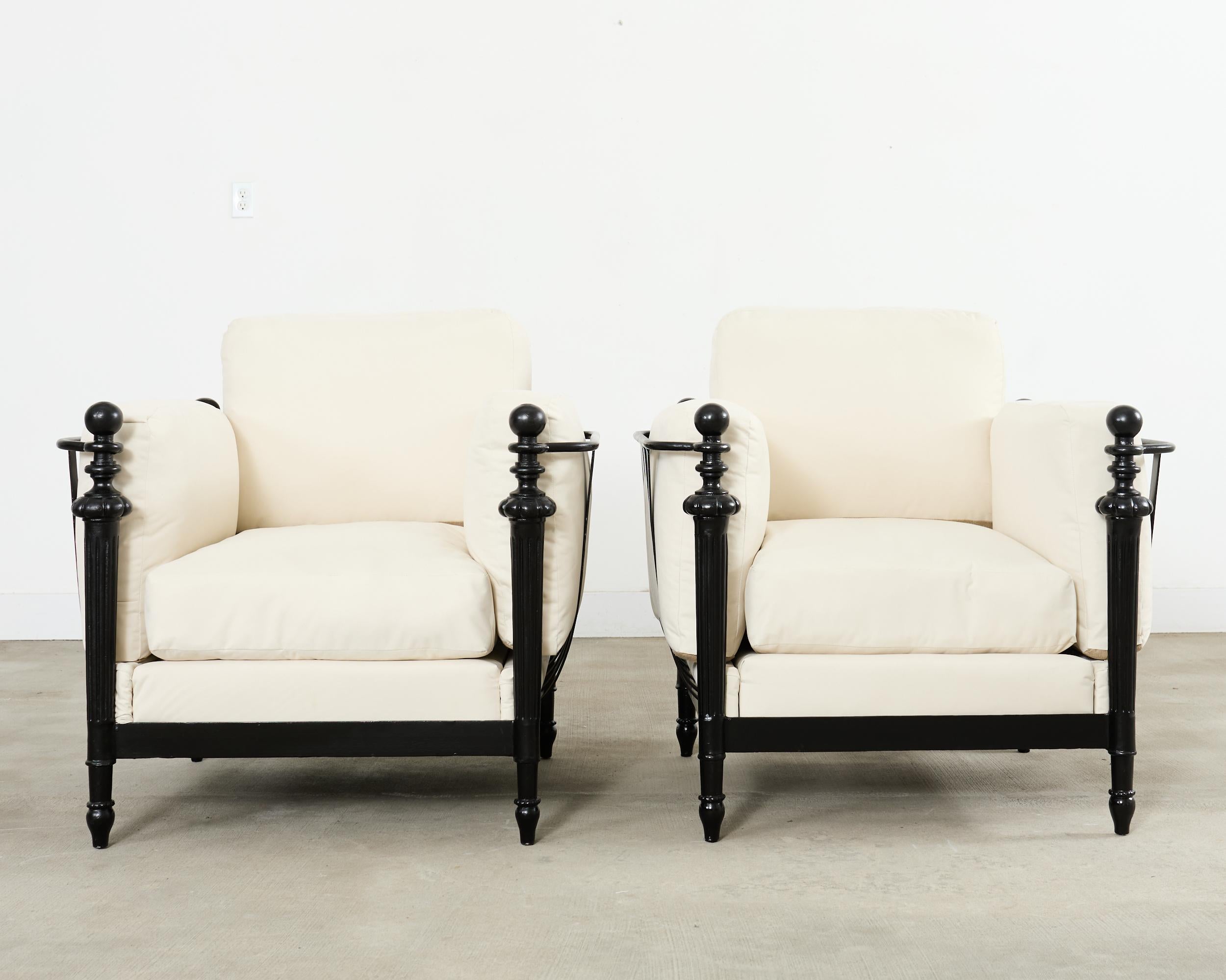 Fantastic pair of iron Montecito patio and garden lounge chairs after Michael Taylor. Crafted from iron by a foundry in Los Angeles, CA featuring oversized basket style Montecito frames with neoclassical inspired design. The generous frames are