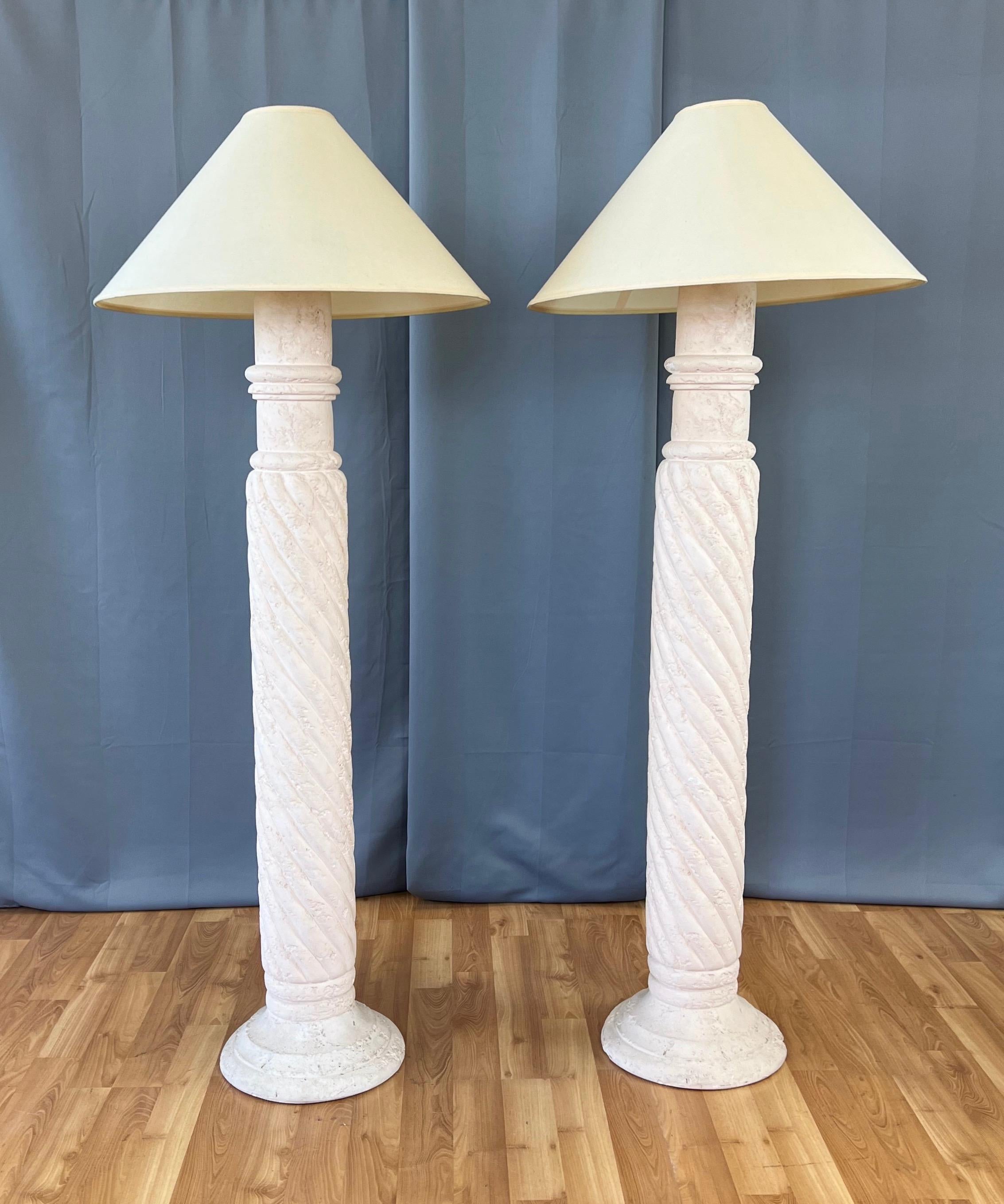 An impressive pair of 1980s pale pink plaster spiral column floor lamps with shades, done in the manner of Michael Taylor for Kreiss.

Substantial column with a tightly-twisted spiral body, Roman-style multi-band capital, and broad stepped base.