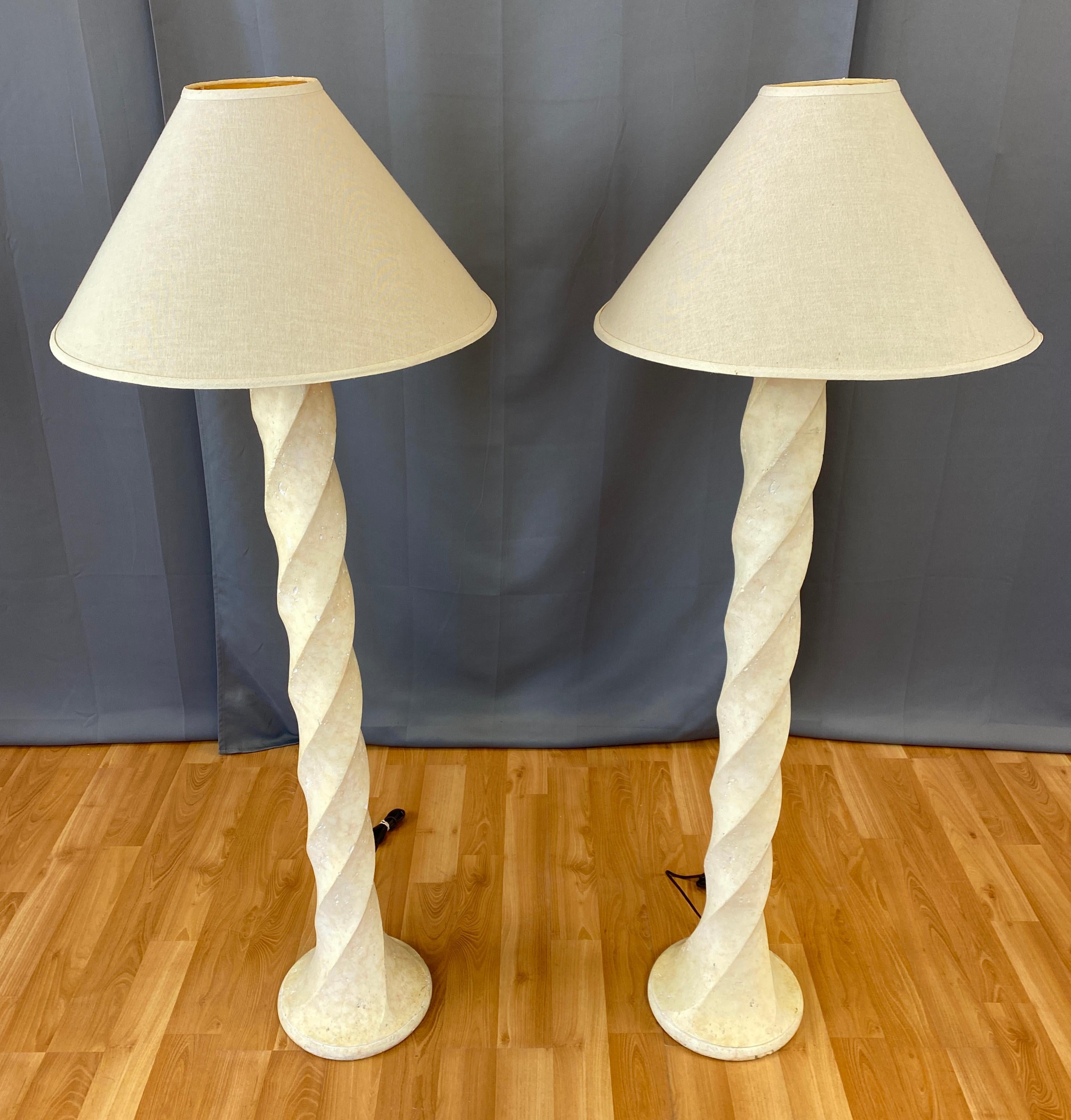 A classically chic pair of tall spiral plaster floor lamps, in the style of Michael Taylor's designs.
Architectural and timeless, with sculptural corkscrew columns that transition smoothly to perfectly proportioned bases. 

Shades are 6 1/8 top,