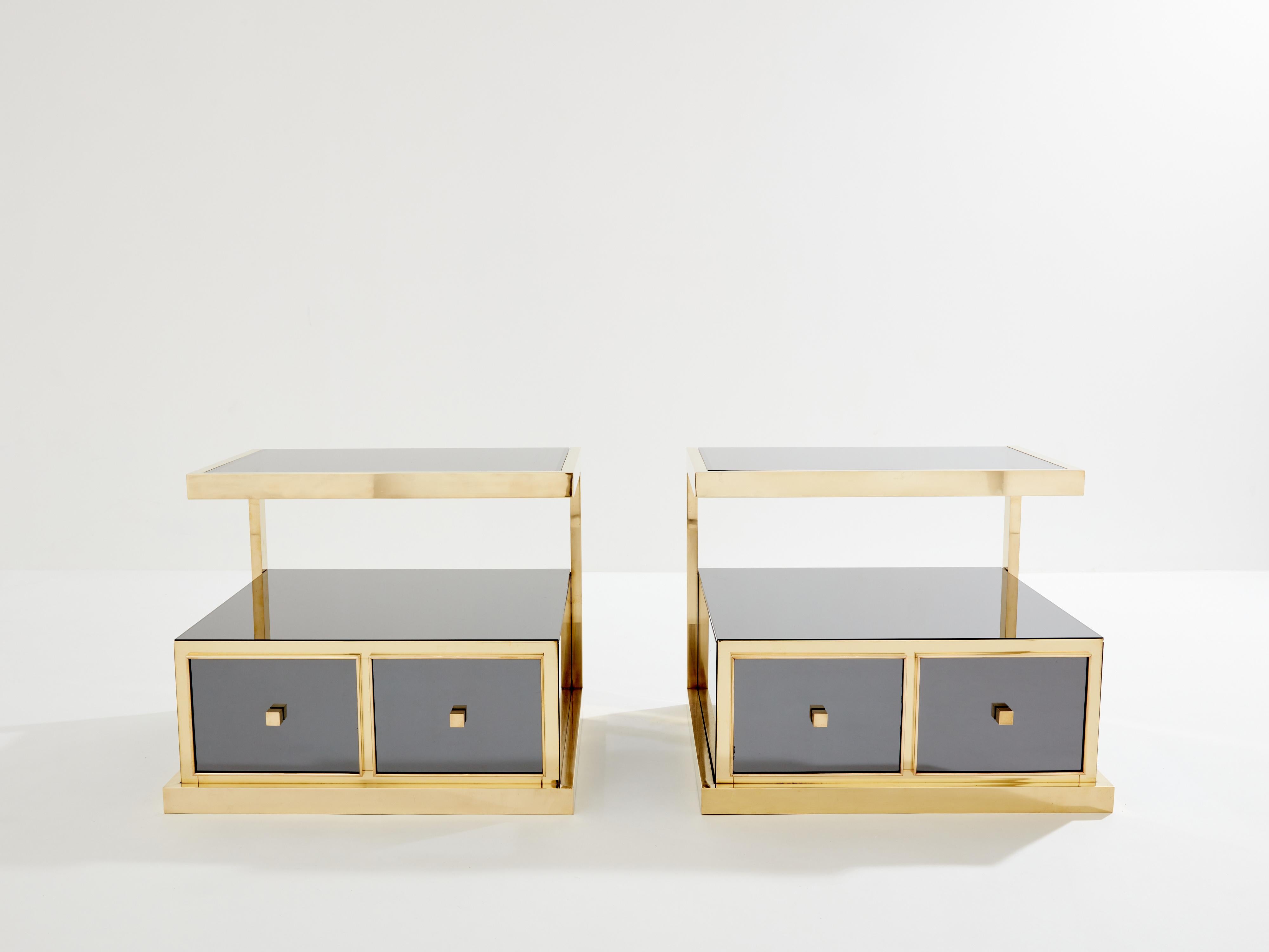 This rare pair of two-drawers grey smoked mirrored and brass side tables, or bedside tables, would be stunning in any room. Designed by Michel Pignères in France in the late 1970s, the mix of polished brass materials with smoked mirrors and smoked