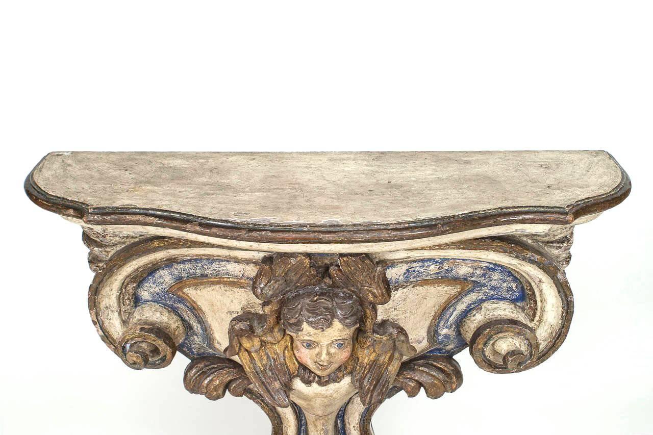 Painted Pair of 18th Century Italian Polychrome and Gilt Limewood Consoles with Cherubs For Sale