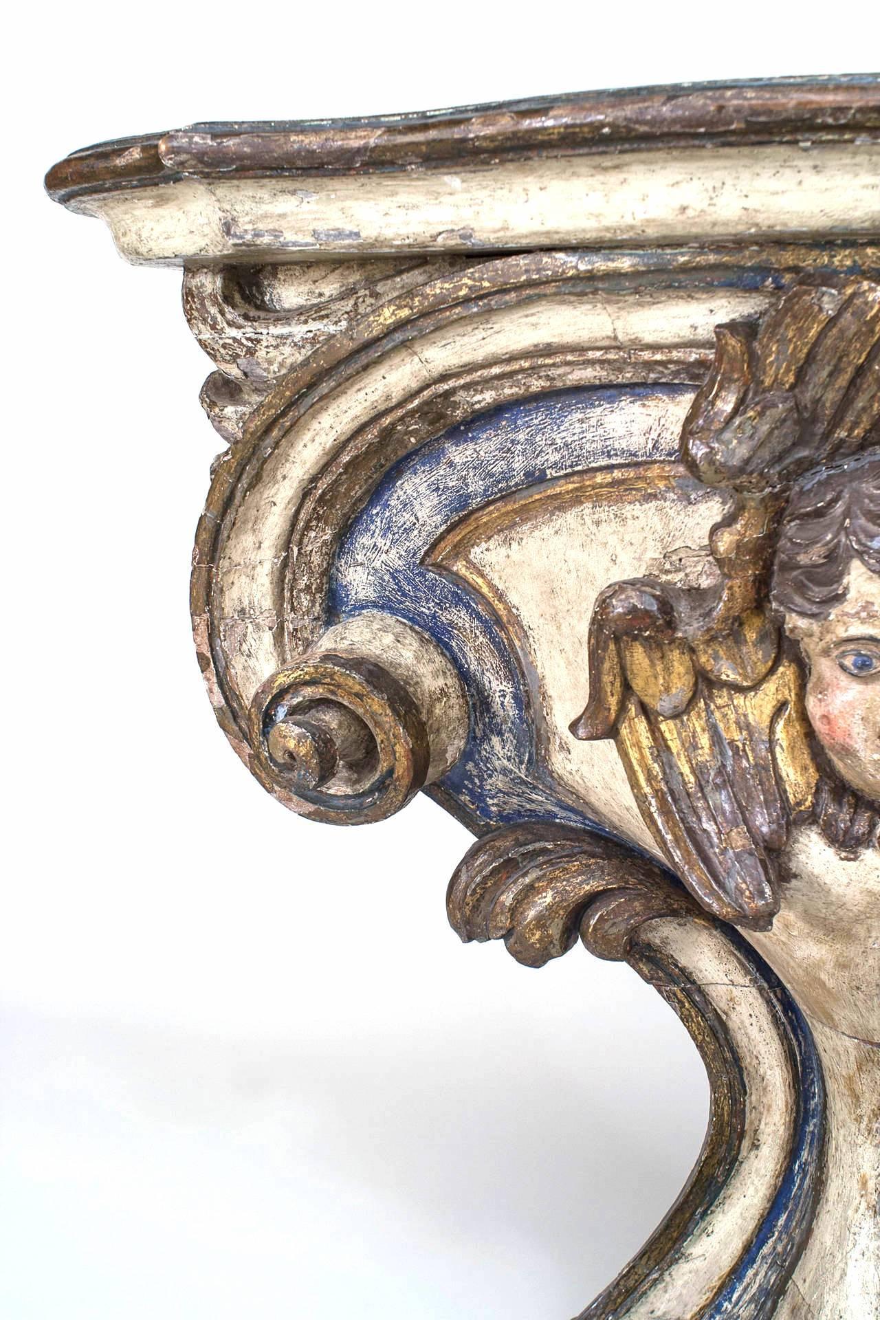 Giltwood Pair of 18th Century Italian Polychrome and Gilt Limewood Consoles with Cherubs For Sale