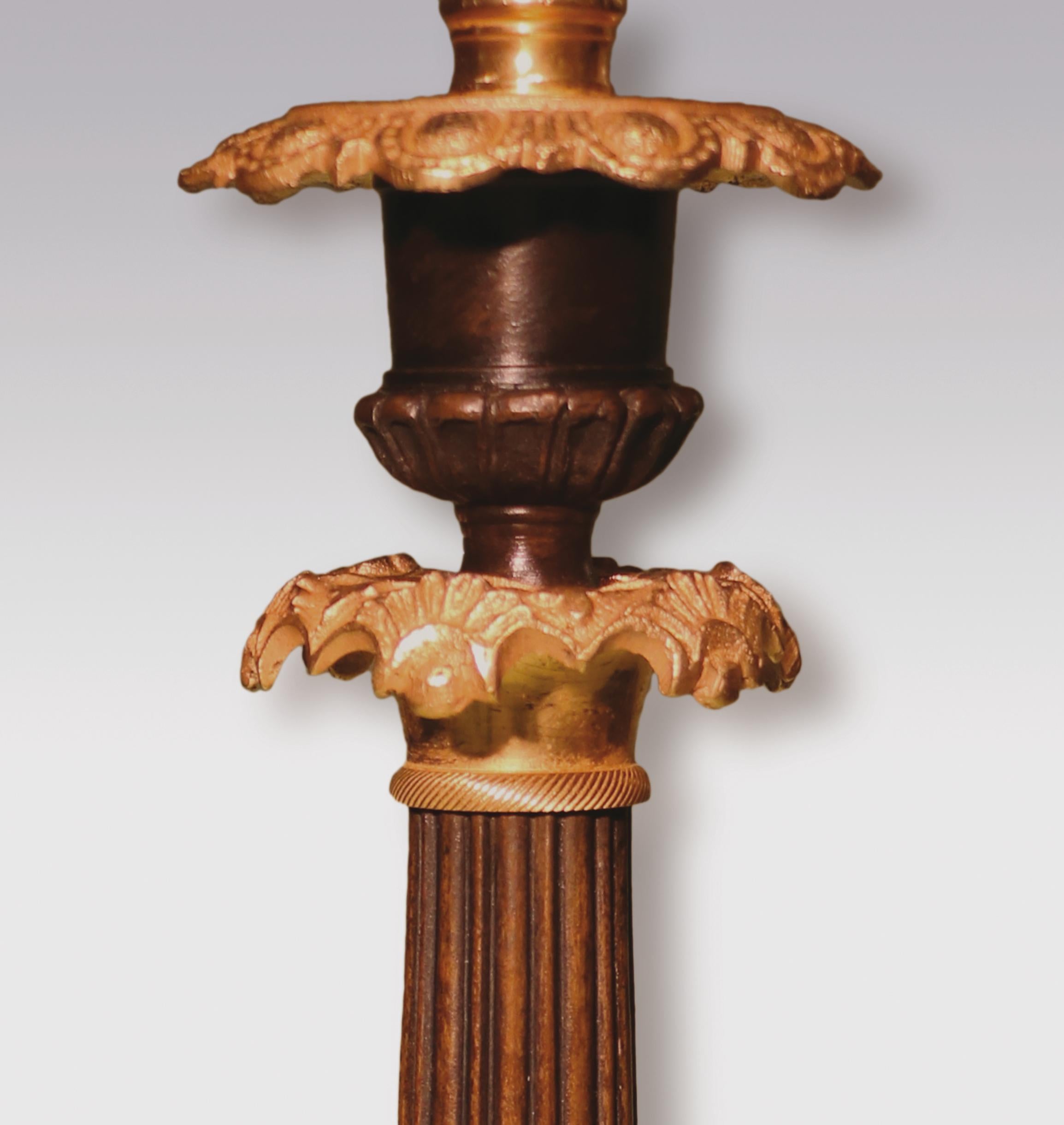 Patinated Pair of Mid-19th Century Bronze and Ormolu Candlesticks