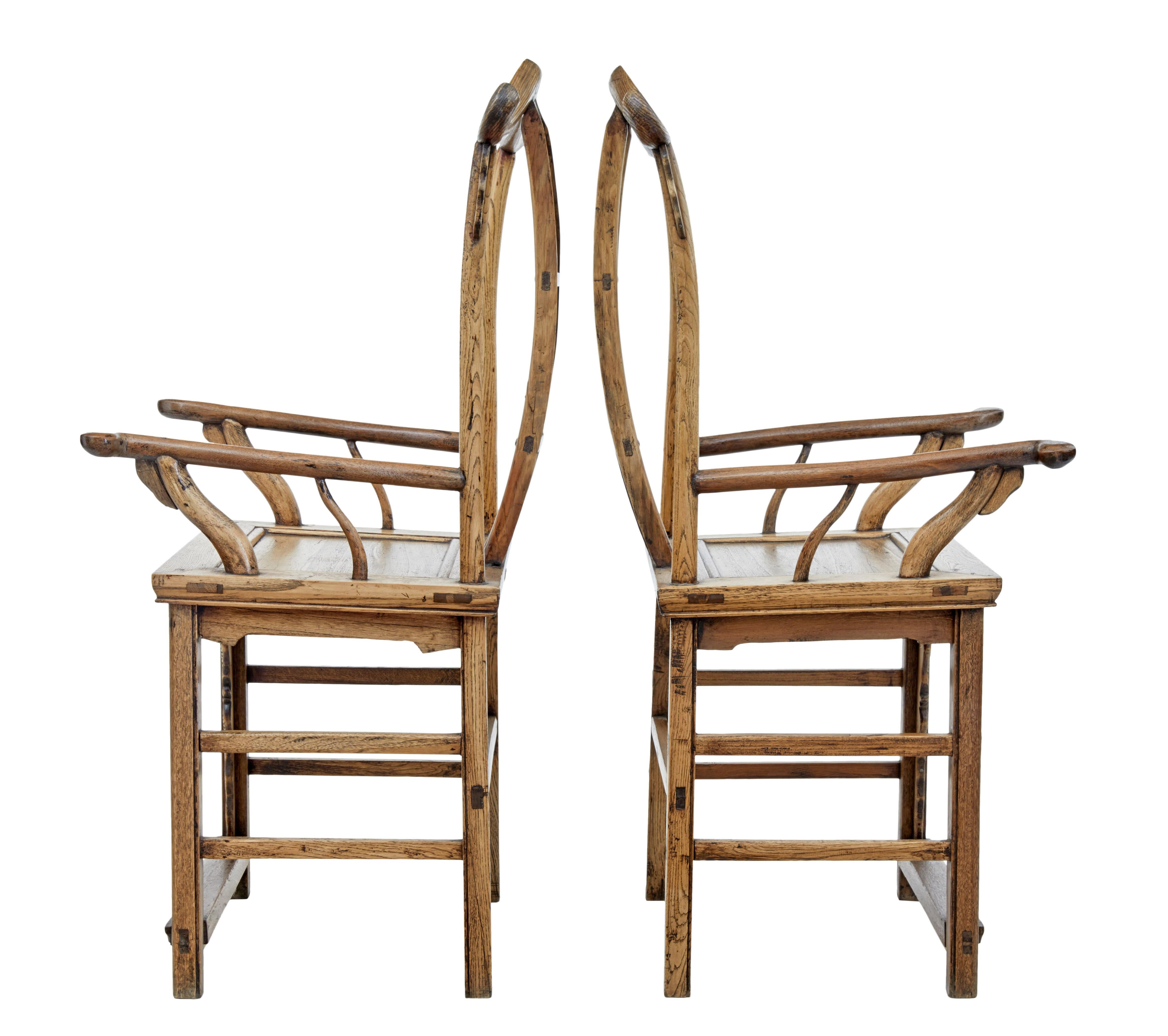 Good quality pair of Chinese yoke back armchairs, circa 1860.

These chairs would have been originally lacquered and have since been stripped.

Carved back panel showing a crane, deer and a bat.

Shaped arms and back rests.

Minor age splits