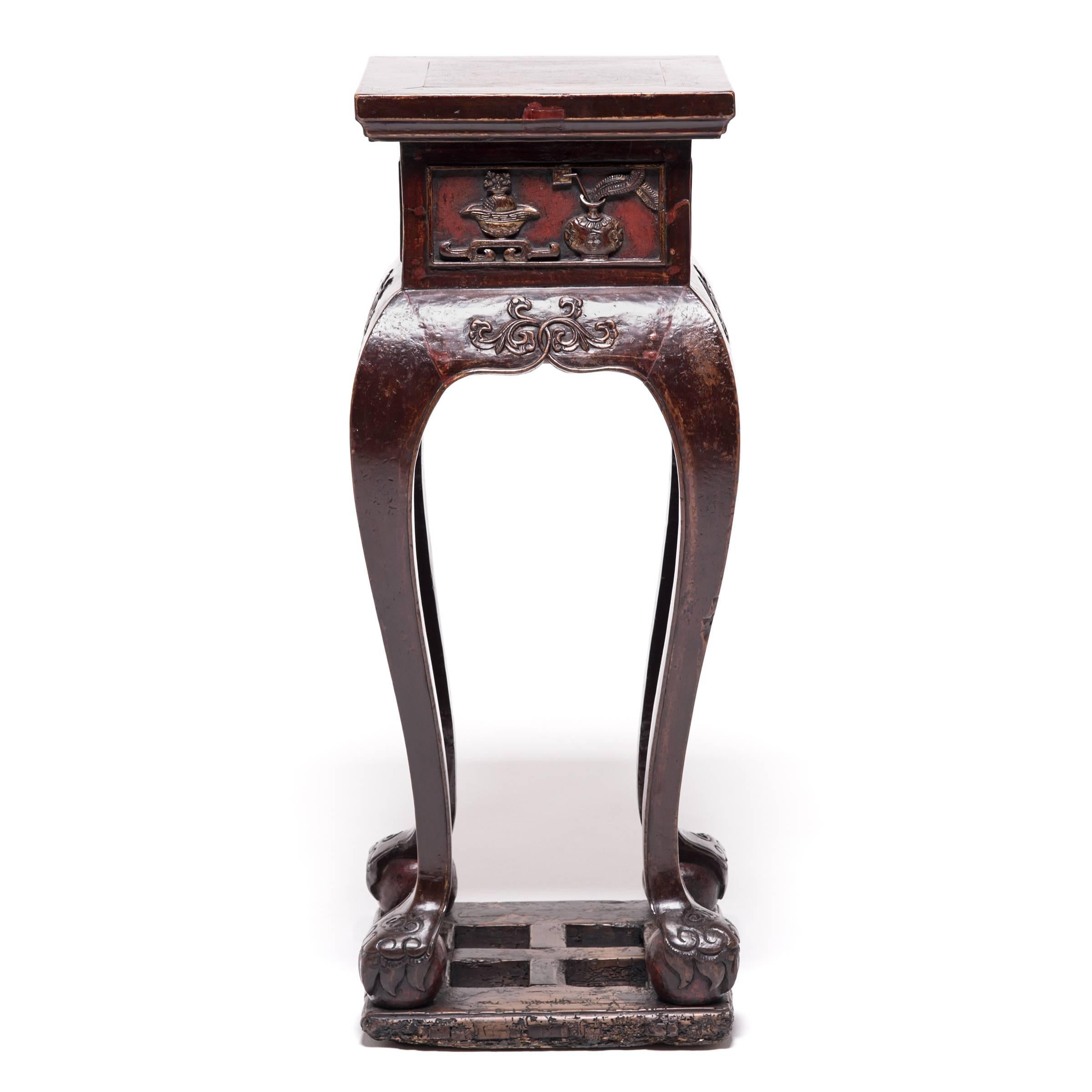 Flowers, teakettles and incense burners, carved here in beautiful relief, were once the very items showcased on this pair of graceful Qing-dynasty table stands. Ornate in design, the graceful tables combine a square table top and curving cabriole