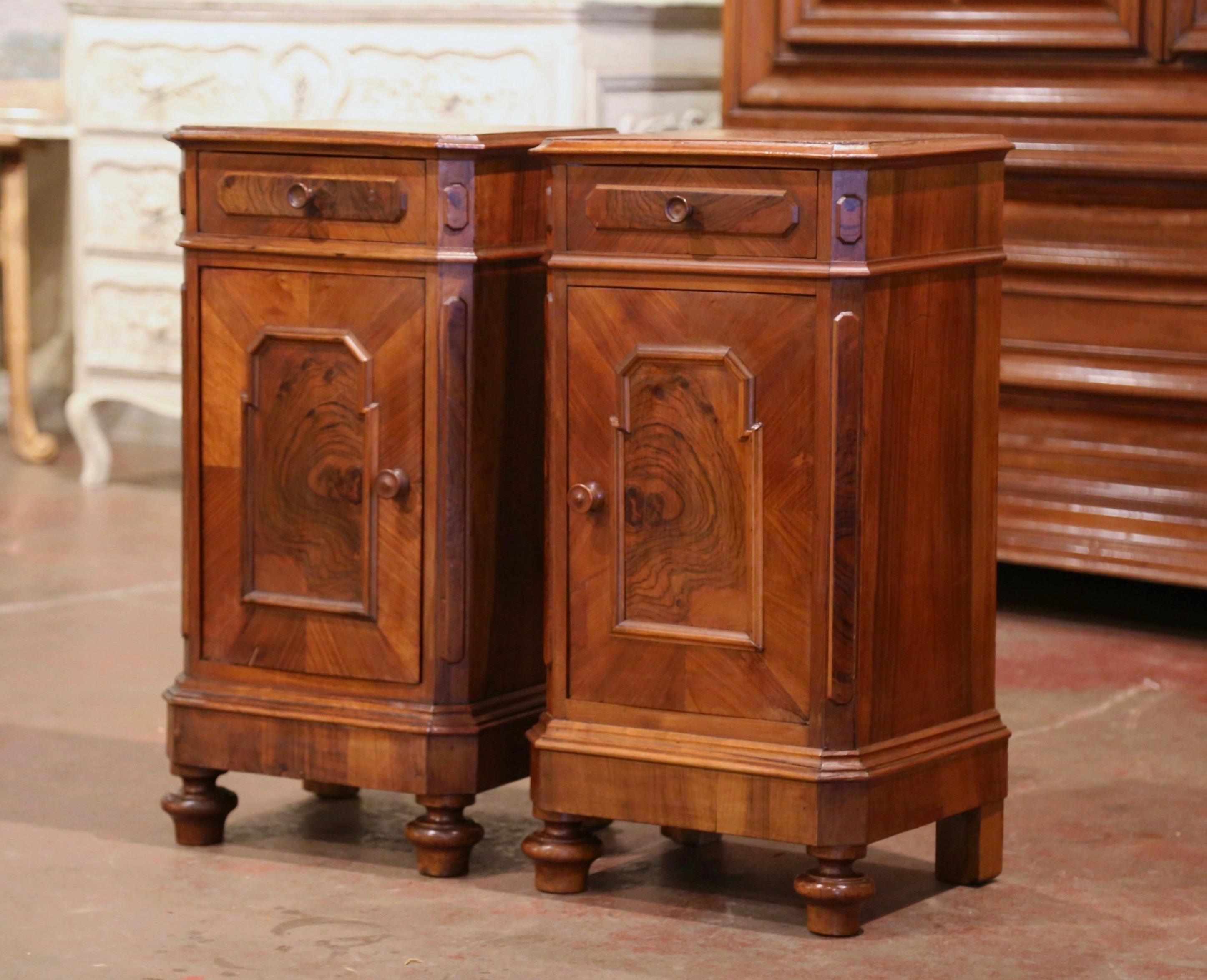 Add surface space in your bedroom with this elegant pair of antique fruitwood nightstands. Crafted in France circa 1860 and made of burl and walnut wood with veneer decor, each Classic cabinet stands on bun feet, and features a single drawer with