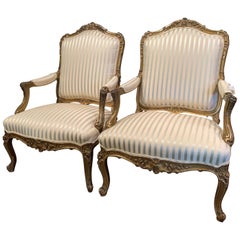 Pair of Mid-19th Century French Louis XV Carved Giltwood Bergères Fauteuils