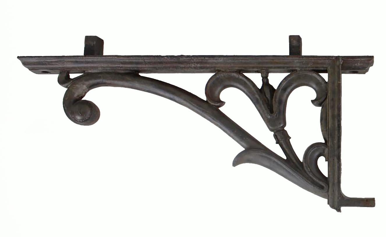 A pair of cast iron architectural balcony brackets of impressive weight and delicate design. 

English or American, c. 1830.