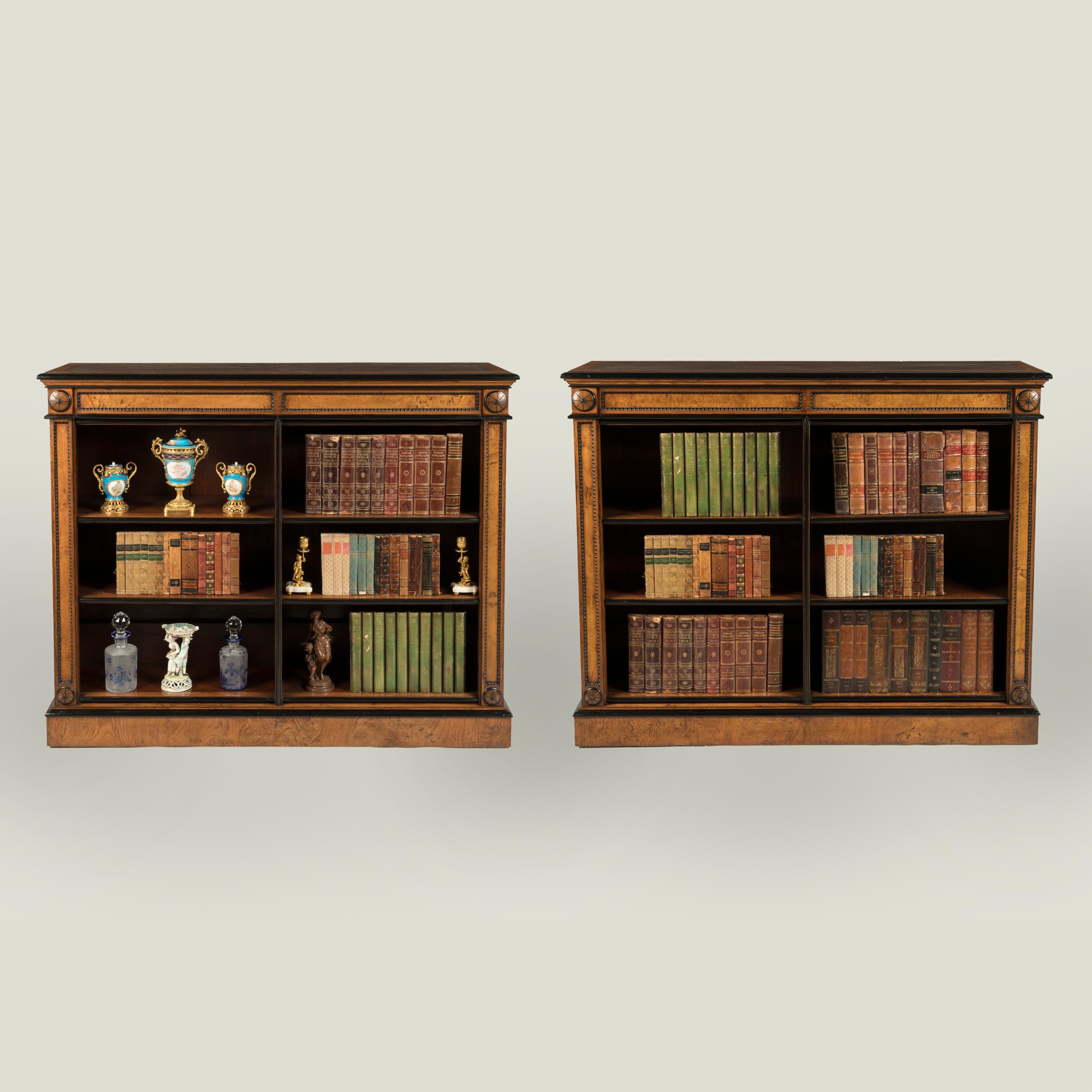 A Fine Pair of Oak Dwarf Bookcases

Constructed from oak with ebonised details; each open bookcase supported on a moulded plinth base; with an arrangement of adjustable shelves, the uprights with recessed panels, carved beaded moulding and with