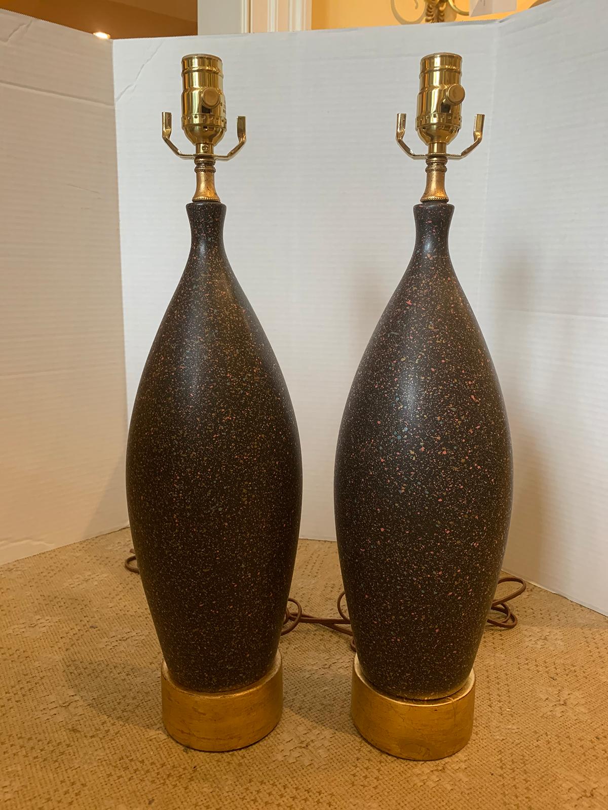 Pair of mid-20th century black pottery lamps on custom gilt bases
New wiring.