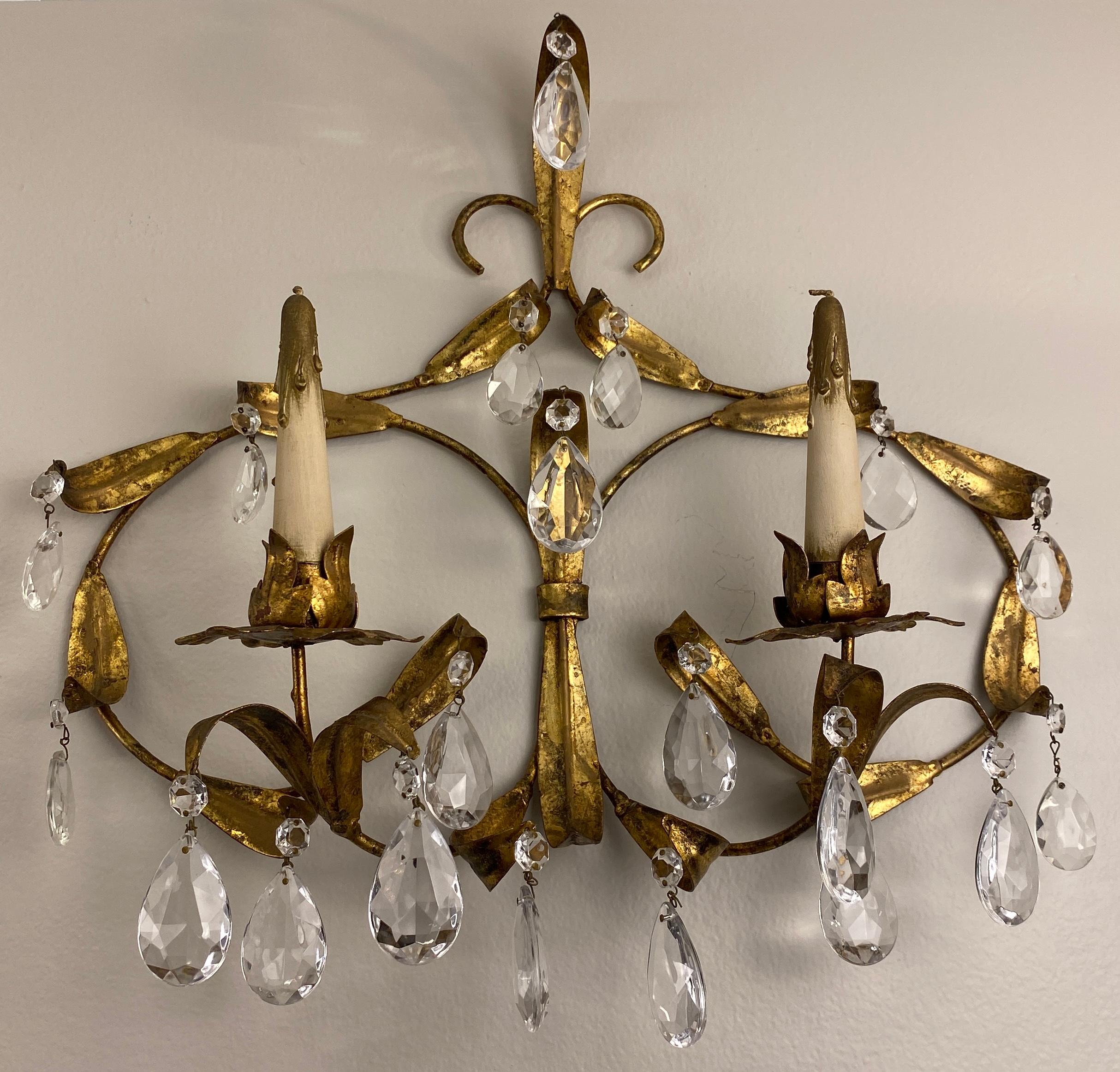 Stylish pair of Maison Baguès brass and crystal wall sconces. Unwired.
These mid-century 2 arm wall sconces are designed and made by Maison Baguès would enhance any contemporary or modern setting. The fine gold gilding, ironwork and crystal makes