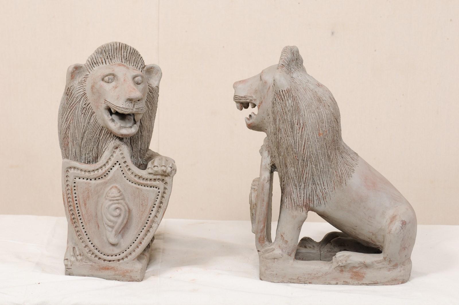 Painted Pair of Mid-20th Century British Colonial Shielded Terracotta Lions For Sale