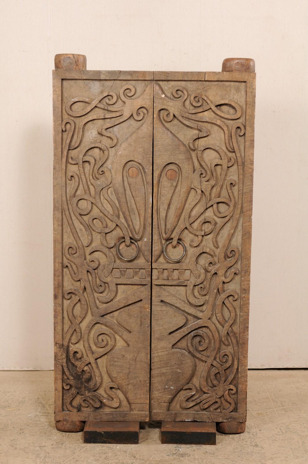 Indonesian Pair of Mid-20th Century Carved Doors from Borneo on Stands For Sale