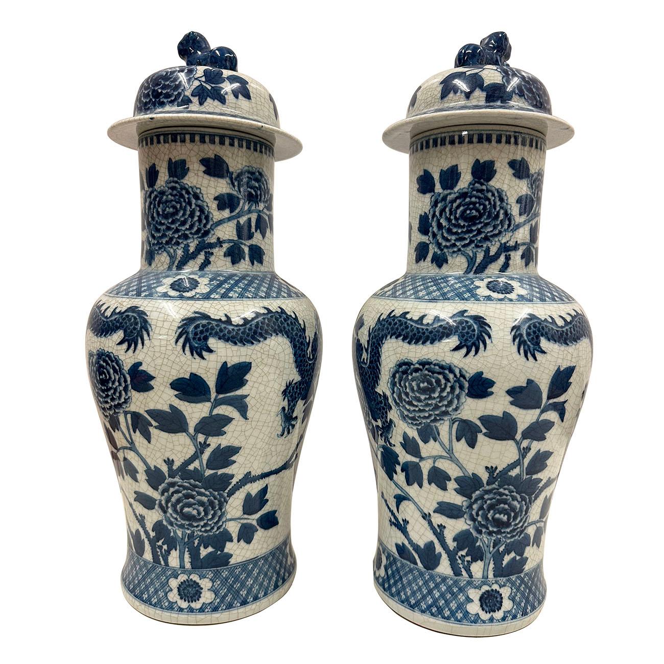 

An exquisite pair of Chinese porcelain lidded vases, in baluster form and beautifully hand-painted with a traditional decoration of Foo Dog and flower on the lid and  Dragon, Floral design on the body. This magnificent Chinese Blue and White