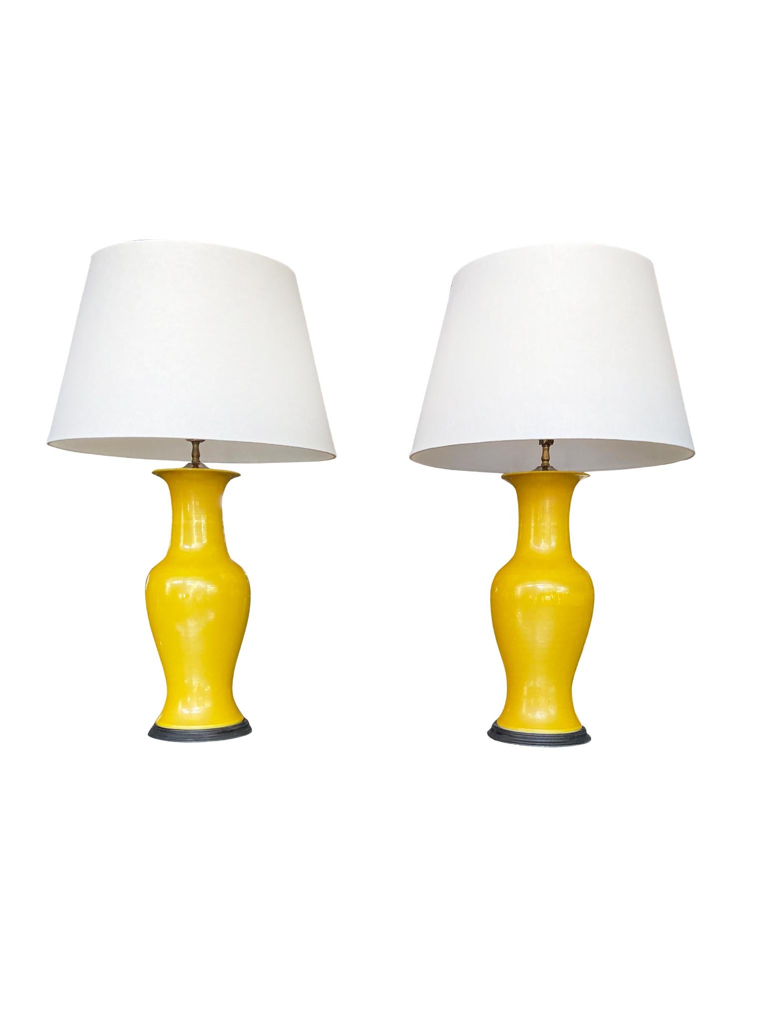 These stunning Mid-20th century table lamps have ceramic vase bodies mounted onto painted wood bases. We love the color of course! These are lamps that brighten the room not just with the lighting but with color. In this case, it is a perfect