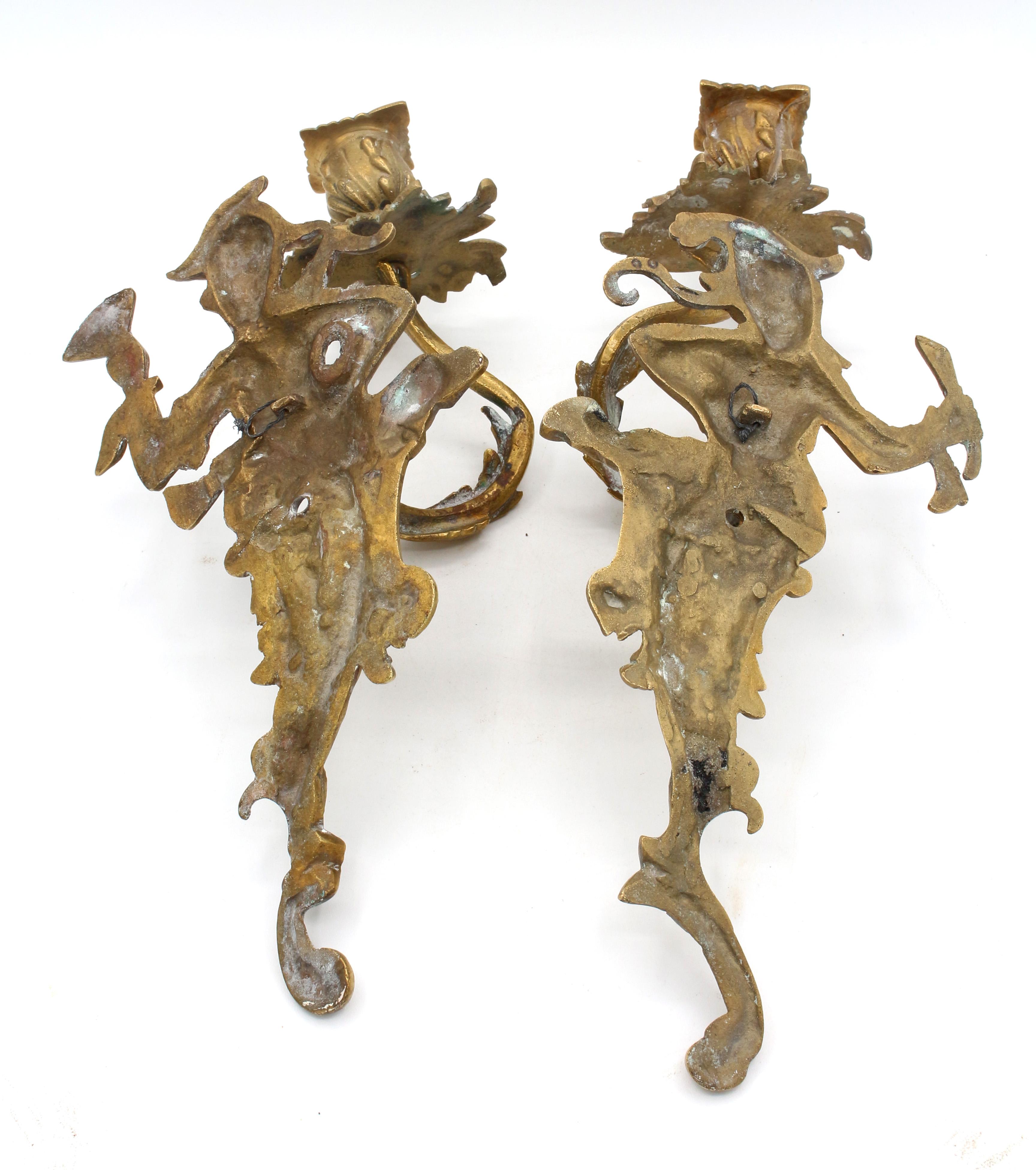A pair of Chinoiserie cast brass double-light sconces, mid-20th century. Once electrified, not currently wired.
12