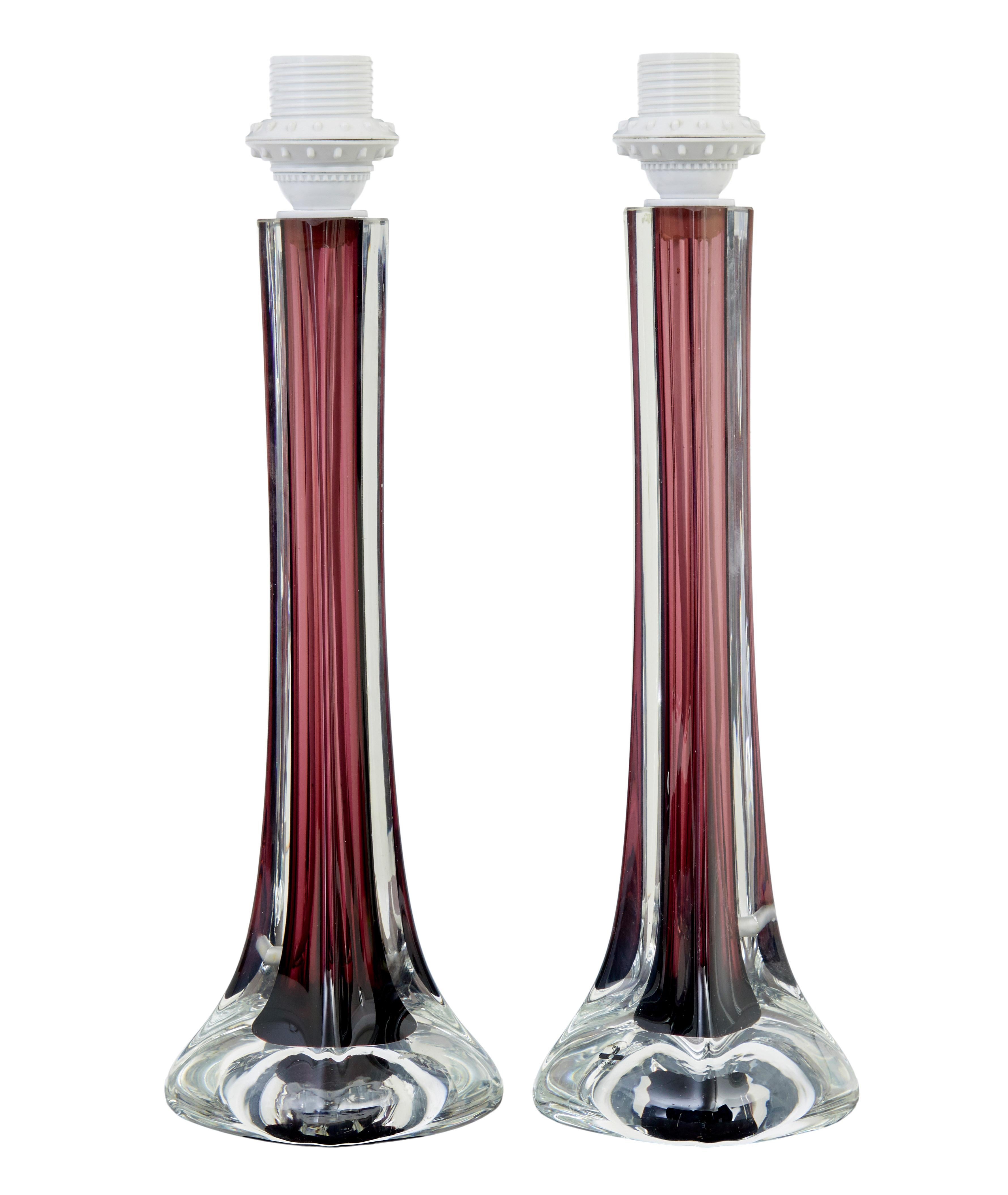 Pair of mid 20th century coloured glass table lamps by Flygsfors of Sweden circa 1960.

Well known model designed by Paul Kedelv, coquille shaped with a burgundy coloured inner stem, flowing down to a bulbous shaped base.

Makers label still