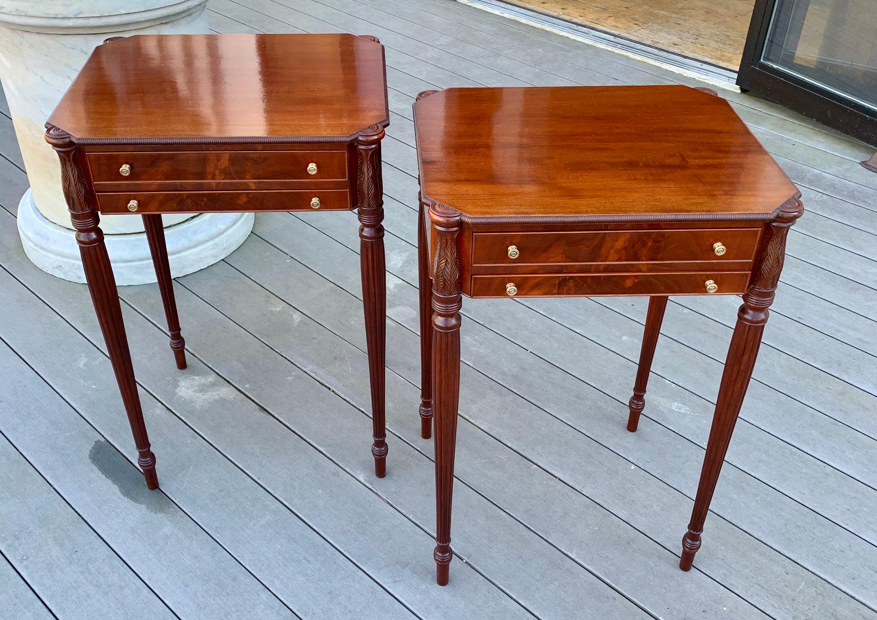 Pair of custom made federal style end or work tables in the style of master Samuel McIntire. Mahogany and hand carved with tapered and reeded legs, acanthus carved top elements and two fitted drawers.