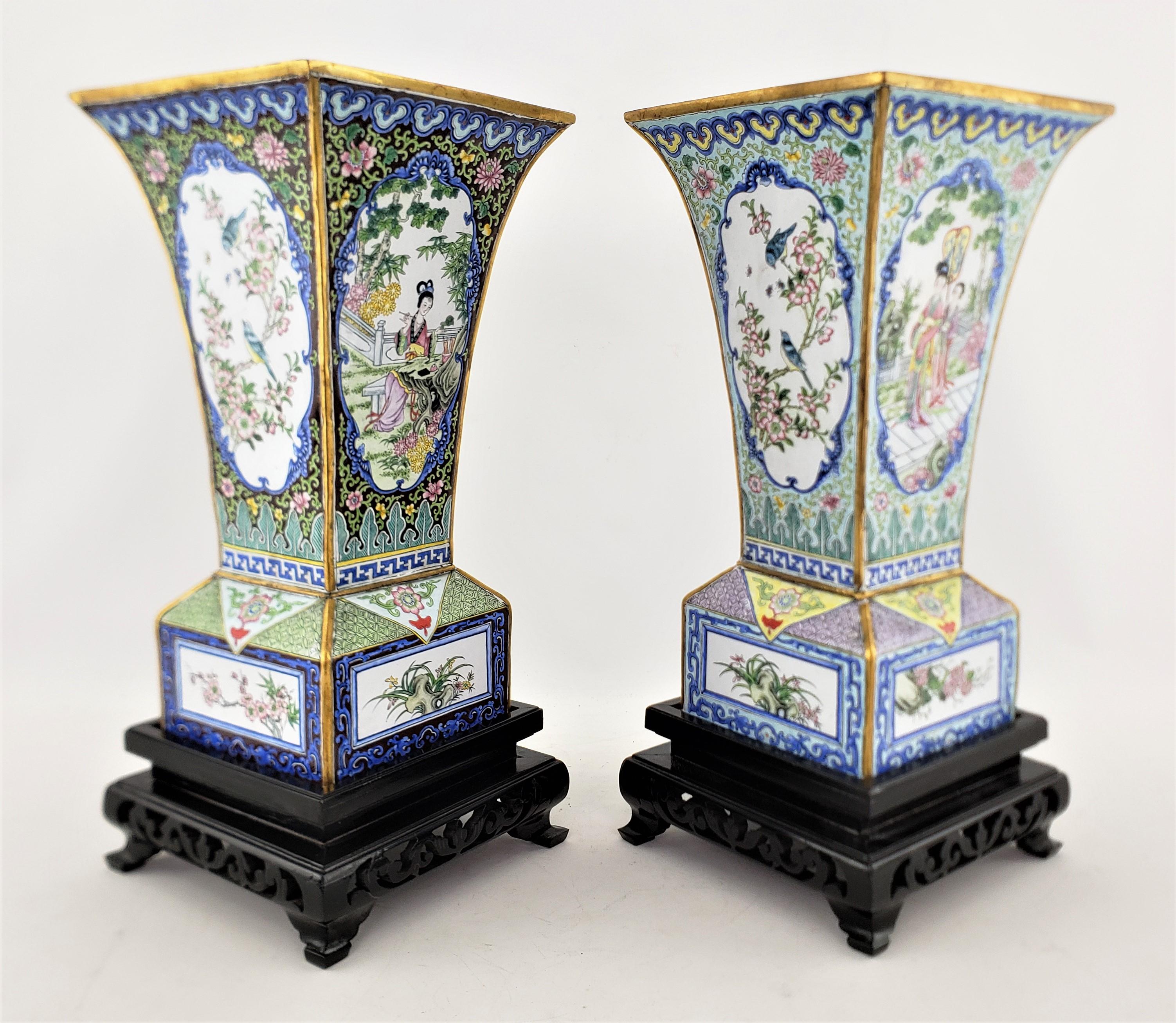 This pair of vases on stands are unsigned, but presumed to have originated from China and dating to approximately 1960 and done in a period Chinese Export style. The vases are composed of copper with tapered sides and block style bases, with very