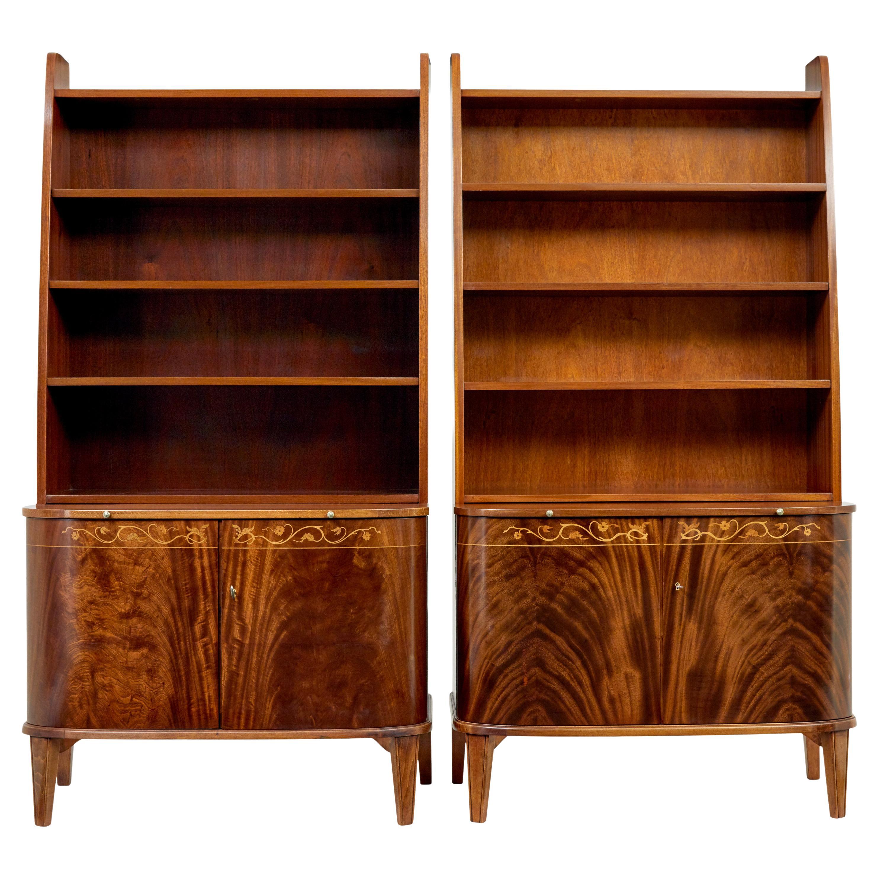 Pair of mid 20th century flame mahogany Swedish bookcases by Bodafors For Sale