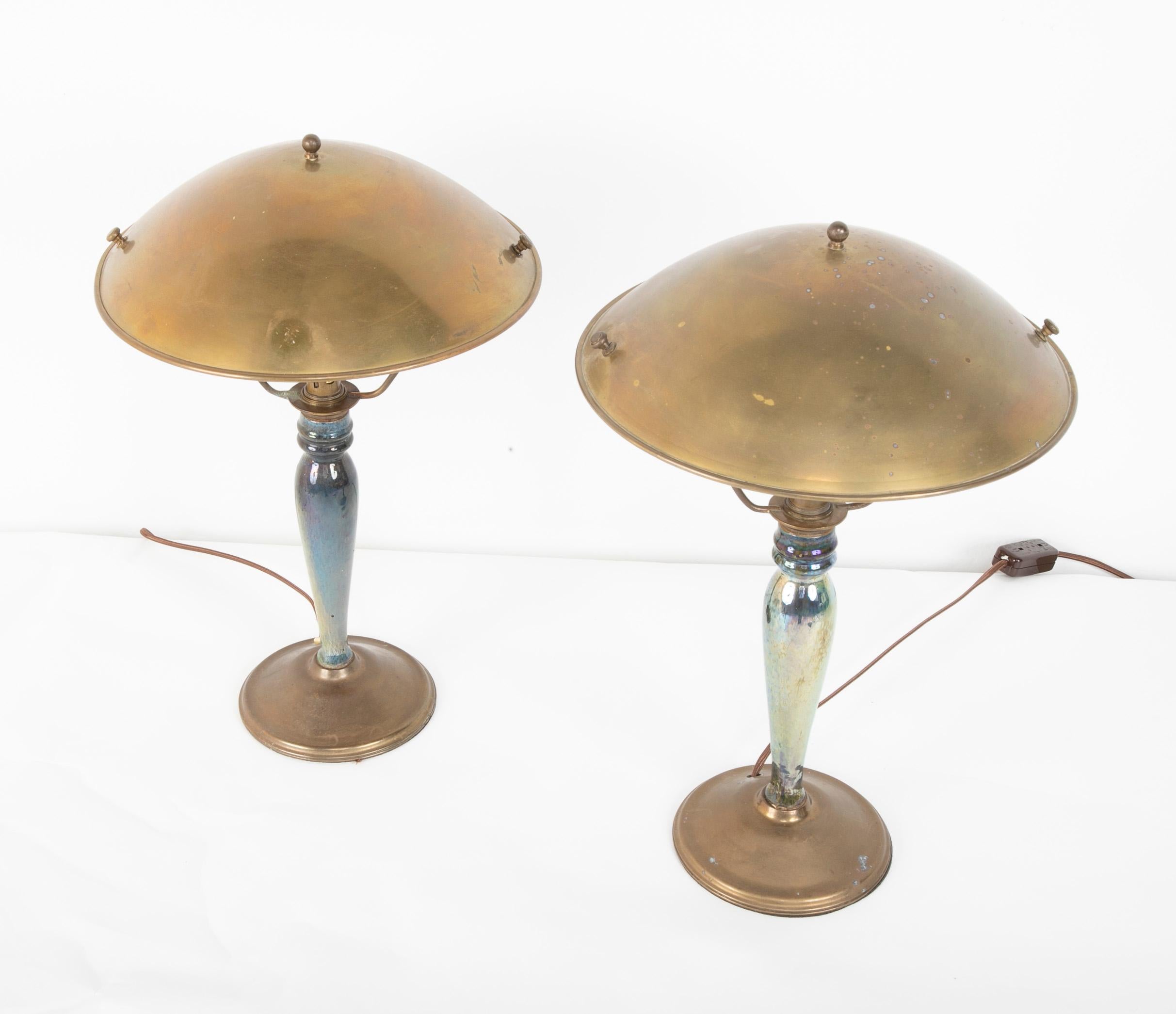 A pair of mid-20th century French blue/green irradecant glazed earthenware lamps with metal shades. The base having VF Deposit written on them.
 