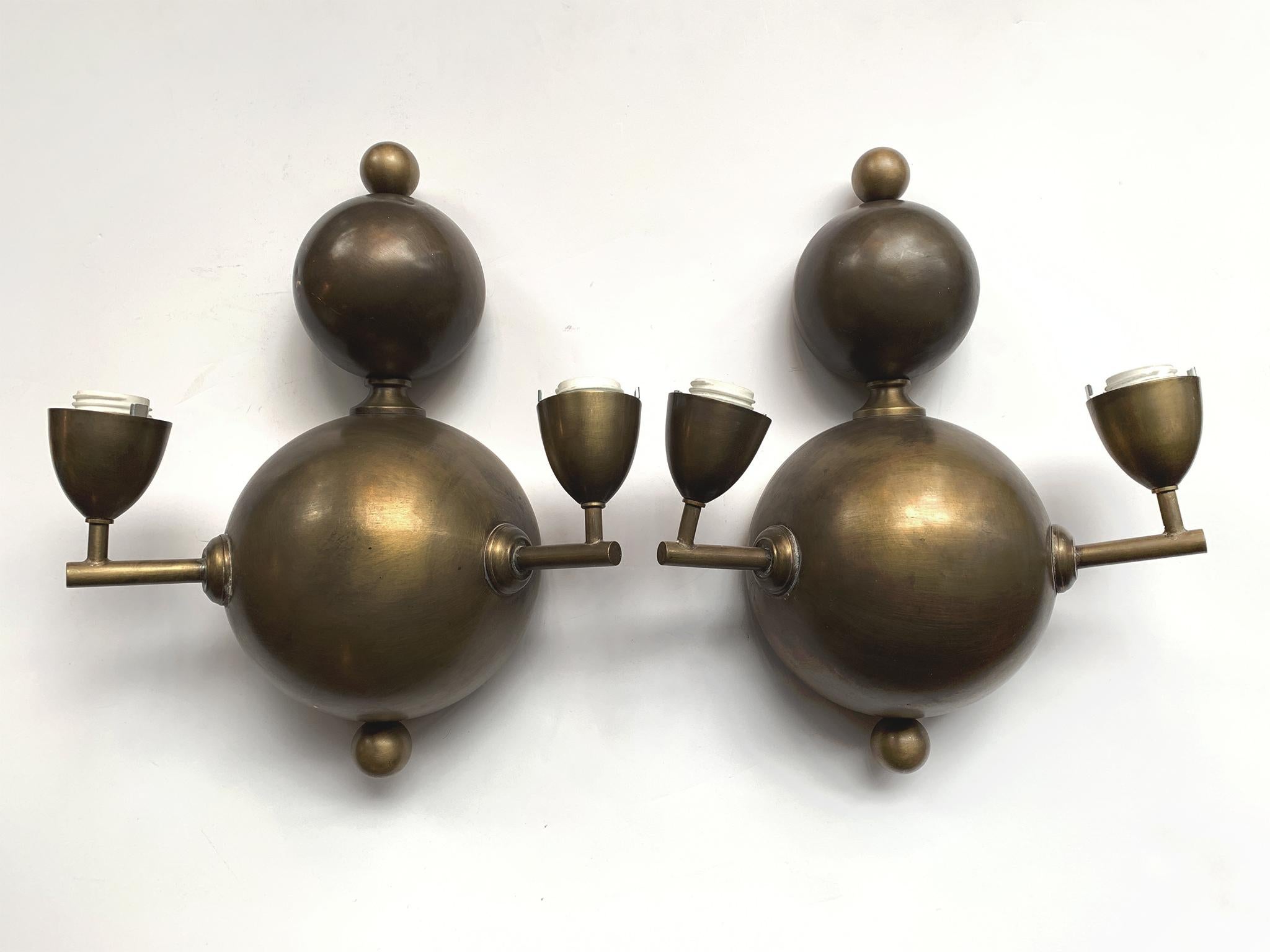 We love this pair of French sconces for their inventive forms, which bring to mind all the elegant qualities of Art Deco, modernism, and Space Age designs. Hemispheres make up the wonderful structure of the sconces capped at top and bottom with