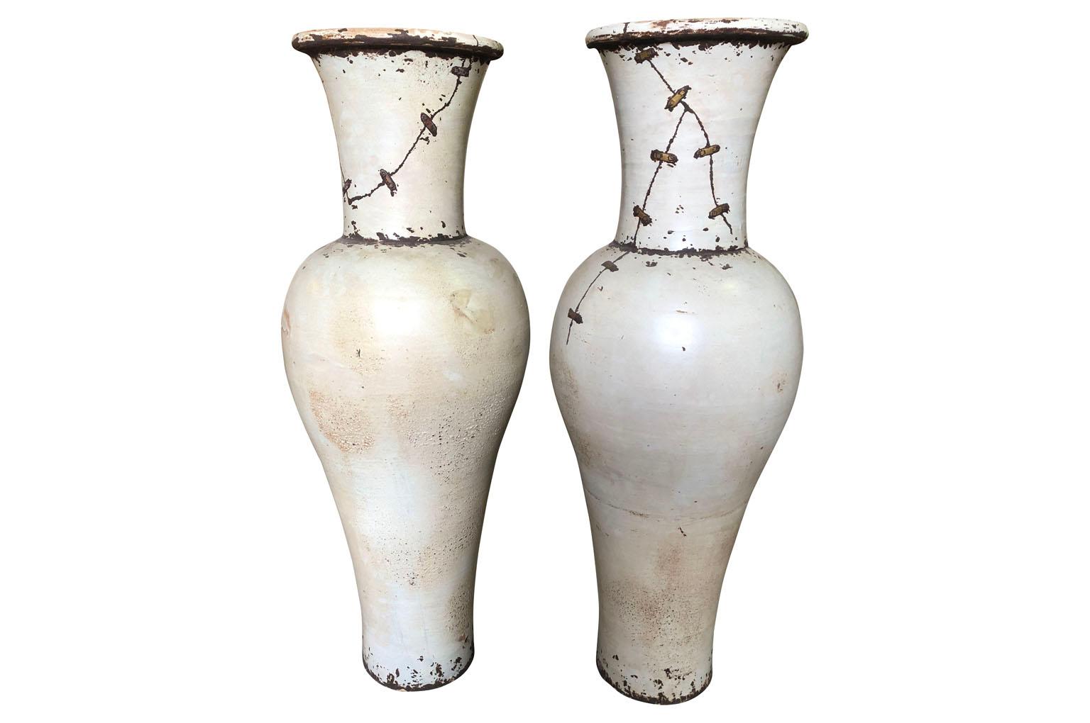 A fabulous pair of grand scale mid-20th century glazed ceramic vases from the South of France. Elegant minimalist lines with wonderful metal detailing.