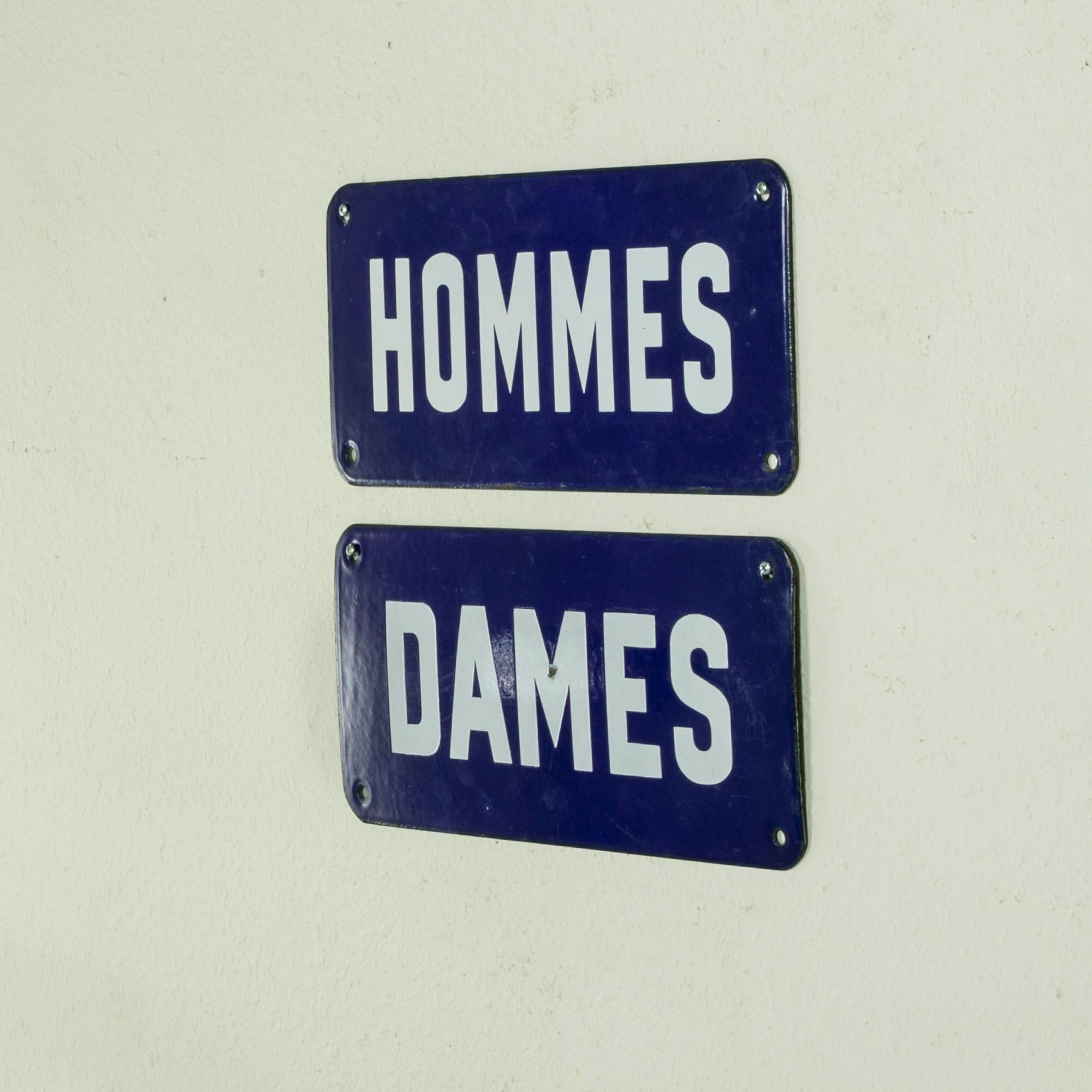 This pair of mid-twentieth century French enameled signs are marked Hommes and Dames which translates to Gentlemen and Ladies. In a charming blue and white, this pair would be ideal for a his and hers bathroom. c. 1950.