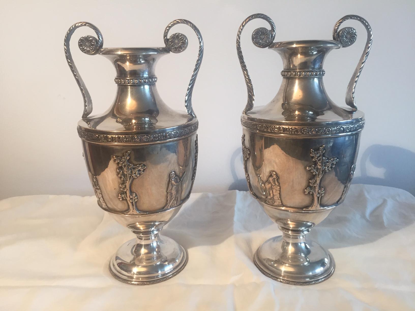 Pair of mid-20th century Italian .800 silver vases or trophy cups, hand casted neoclassical style double handled vases. They bear Italian maker's hallmark and the silver mark for European (Italian) Silver. Each cup is embellished with baluster form,