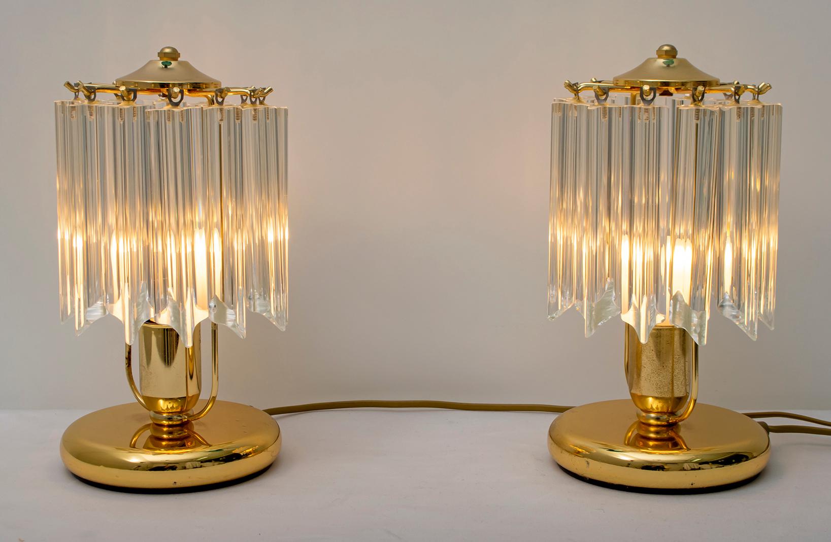 This pair of table lamps has a brass structure and 12 