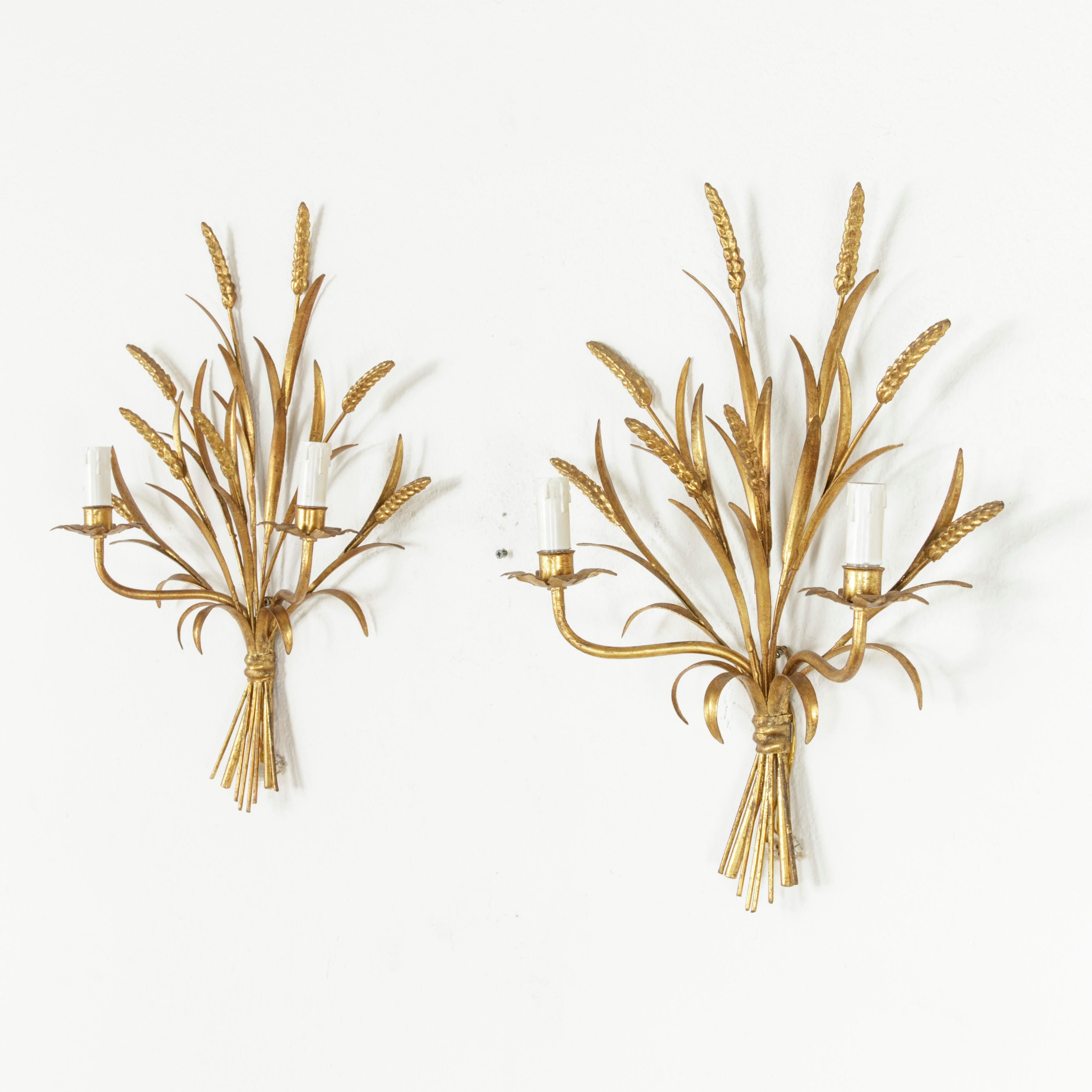 This pair of Italian gilt metal sconces is a midcentury Classic with its motif of bound sheaves of wheat. At 22 inches in height, this fine pair makes a grand impact when flanking a mirror. Reminiscent of Coco Chanel's Paris apartment. These circa