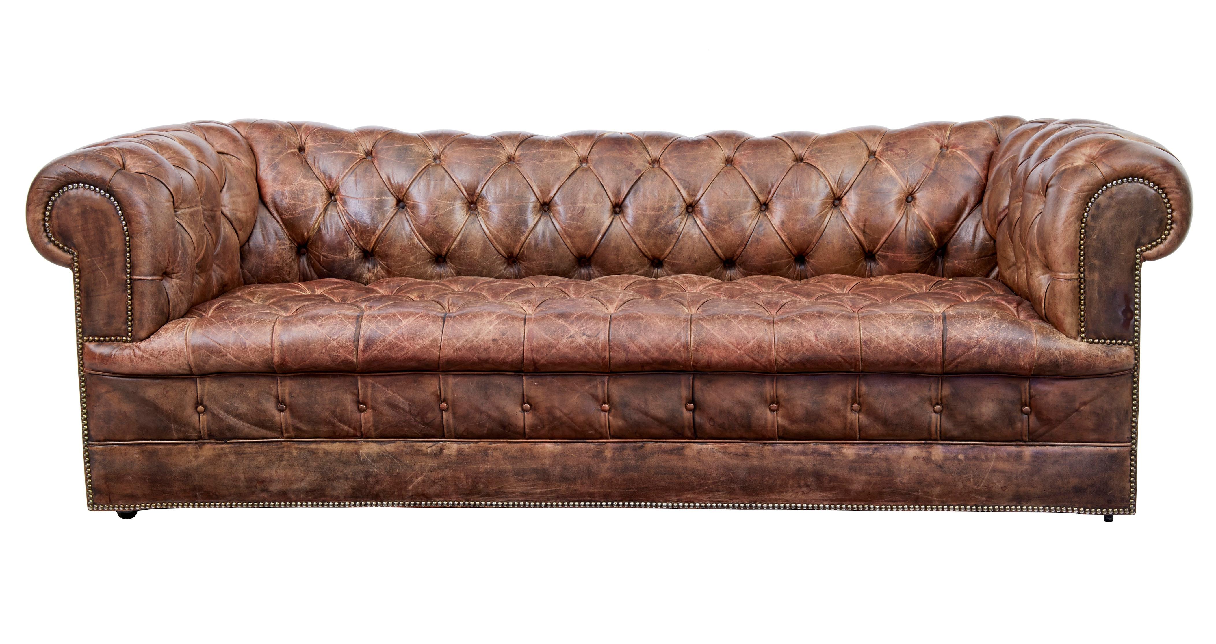 Pair of mid-20th century leather chesterfield sofas, circa 1980.

Large pair of chesterfield sofas. Beautiful quality brown leather with excellent patina. Over stuffed roll top arms and back. Each standing on castors.

2 buttons missing, some