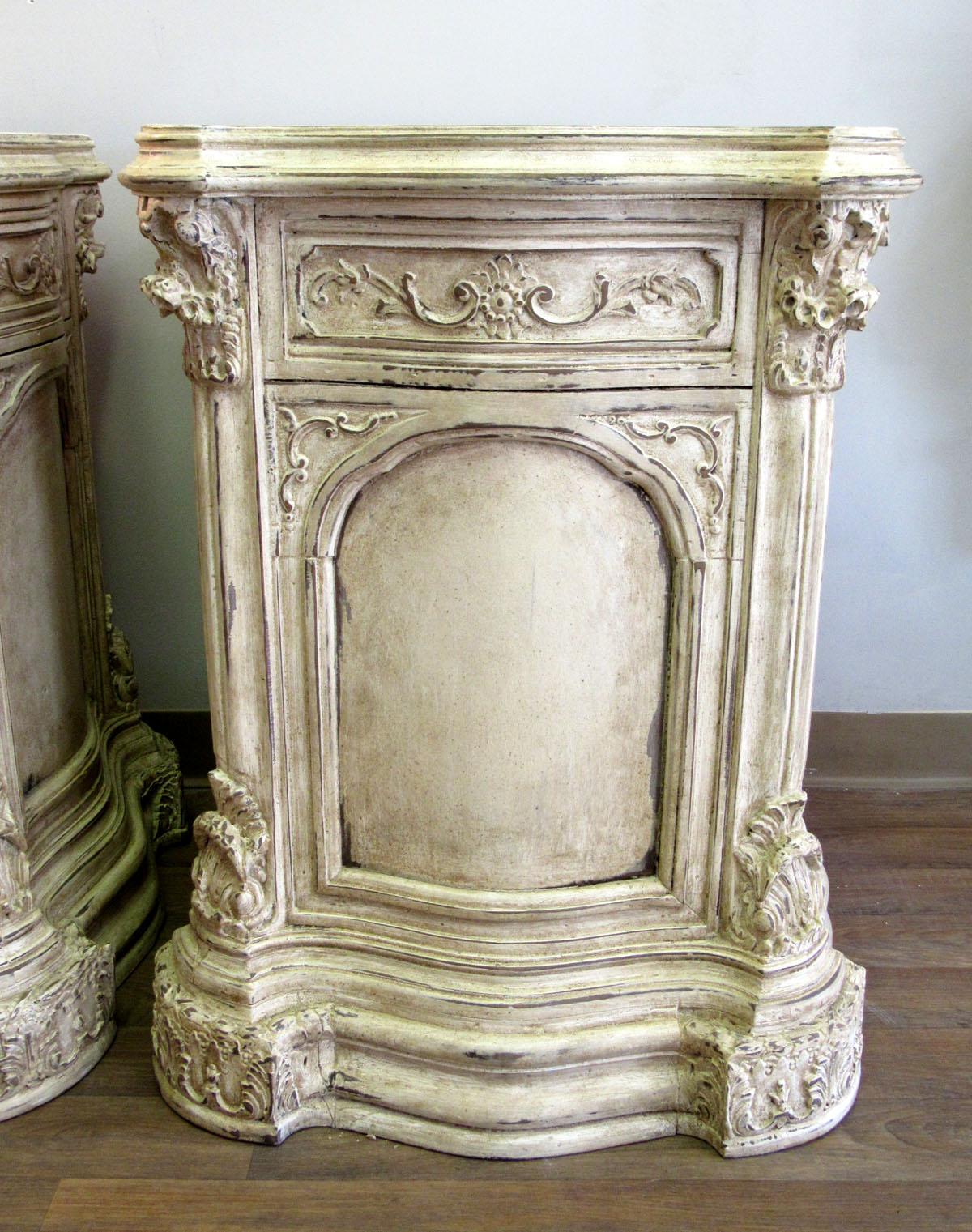 Pair of Louis XV style carved wooden pedestals with ivory painted finish.