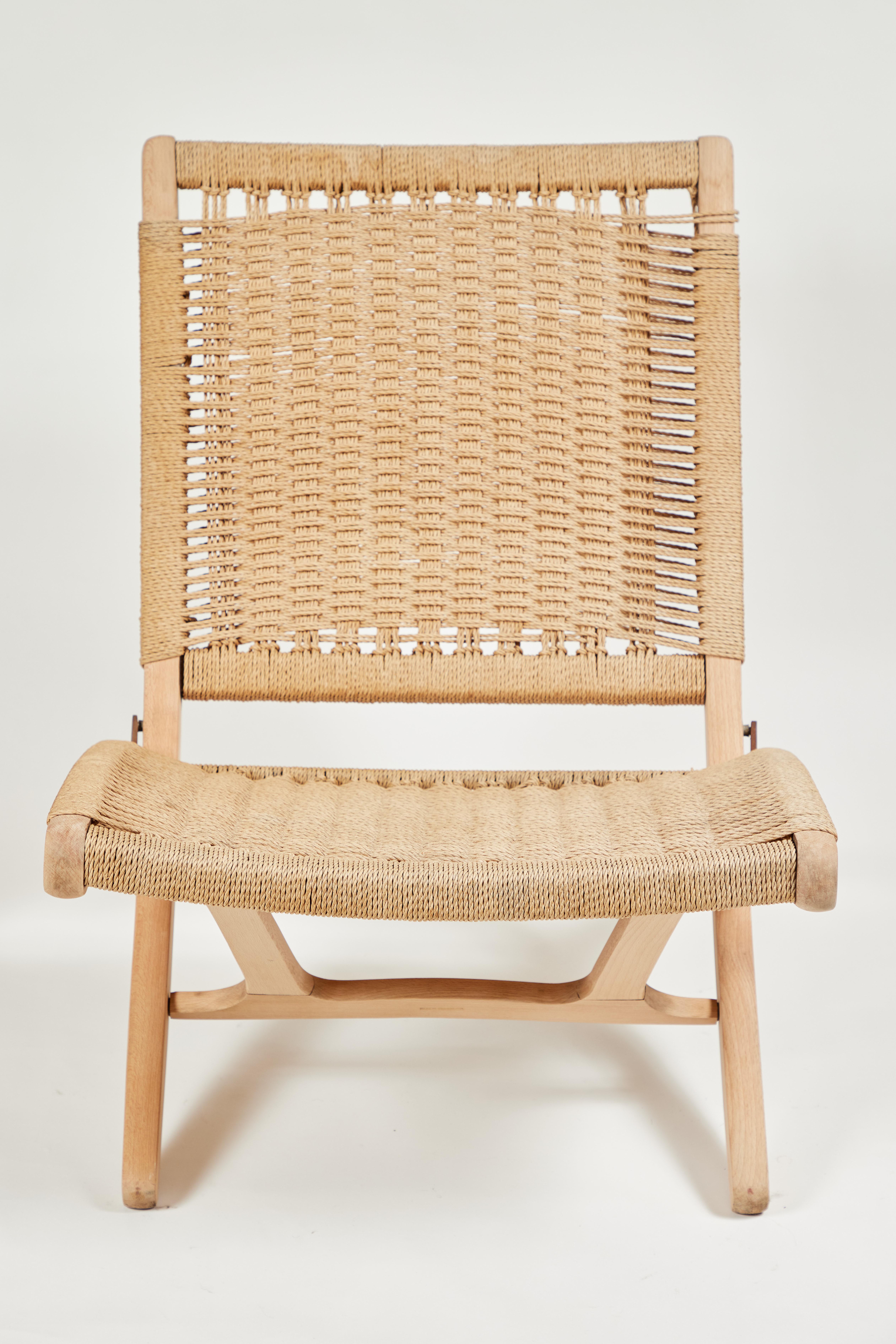 Midcentury Hans Wegner style rush folding chairs, the wood has been sanded to a natural finish. Made in Yugoslavia.