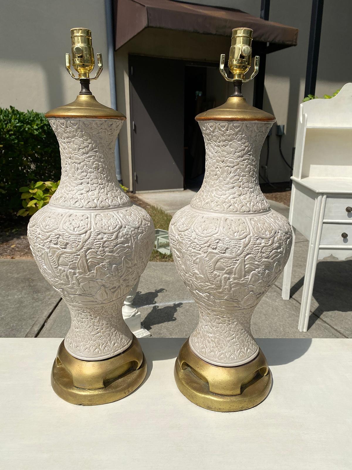 Pair of mid-20th century oriental cinnabar style terracotta lamps with hand-painted custom finish. Giltwood bases.
New wiring.