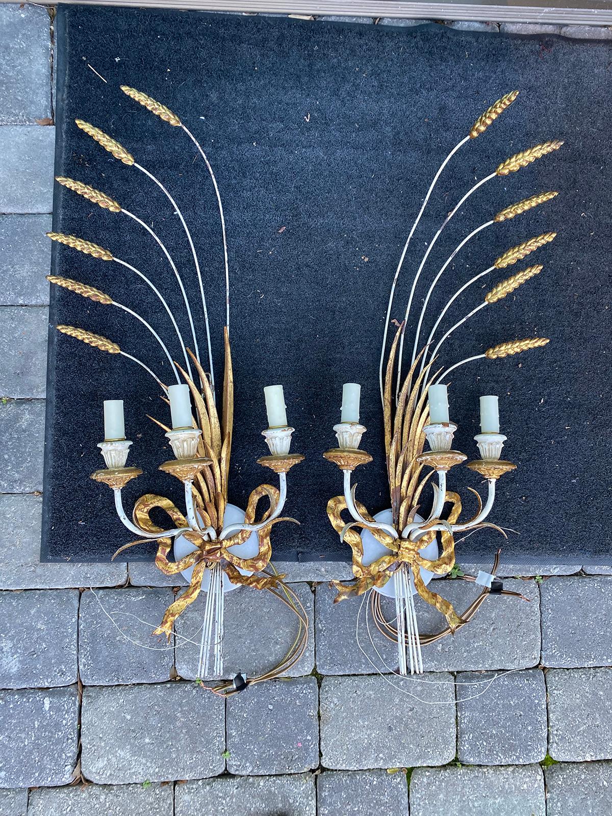 Pair of mid-20th century parcel gilt metal and wood three arm wheat sconces.
New wiring.