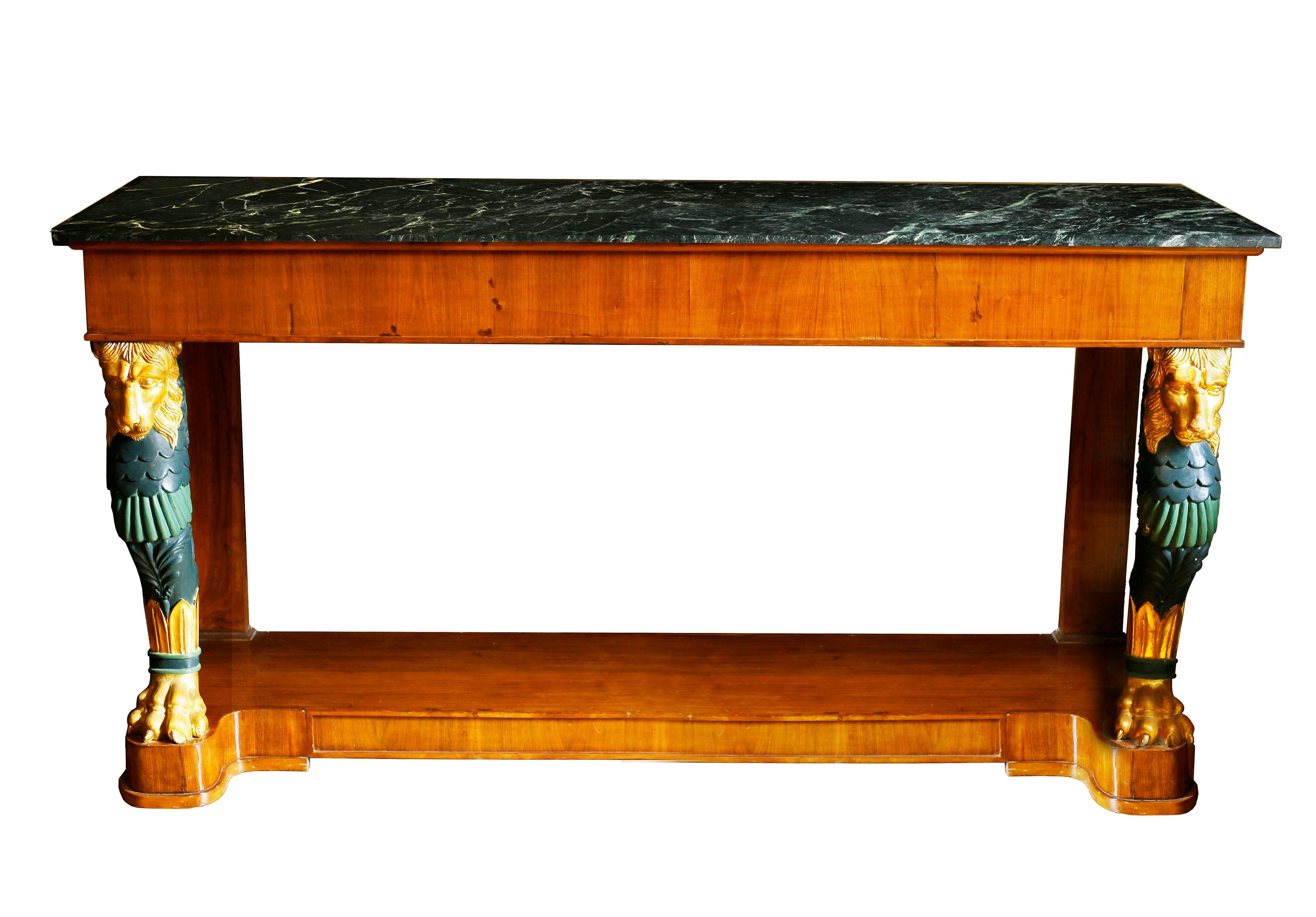 A stunning set of grand midcentury consoles with large lion supports in the style of Charles Percier, Thomas Hope, and George Smith. These classical tables take their inspiration from the French Empire and English Regency designers that infused