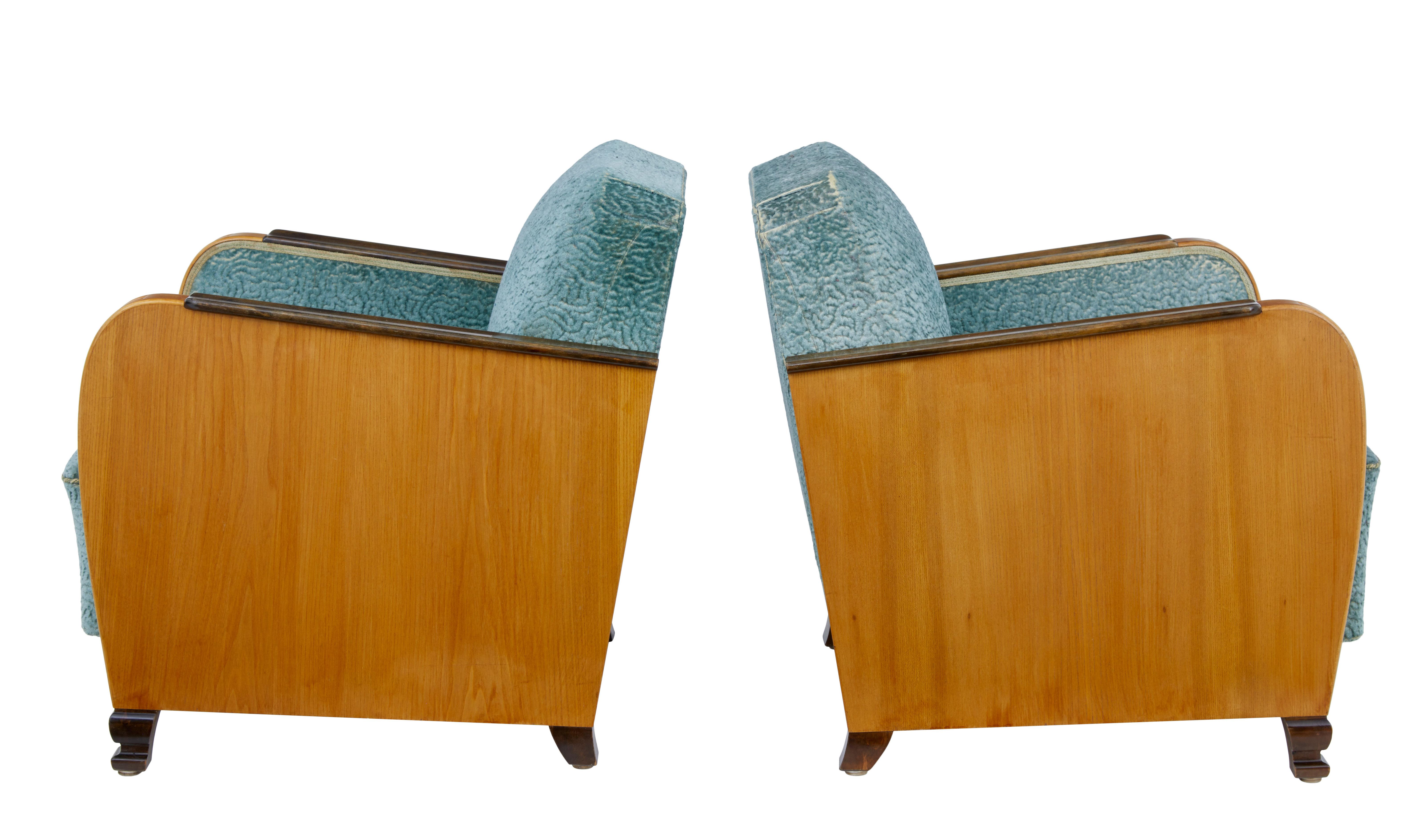Excellent quality pair of armchairs, circa 1940.

Elegant pair of late art deco chairs, featuring beautiful elm sides and arms. Arms with channeled detailing to the fronts. Applied stained birch shaped arm rests and matching feet.

Original