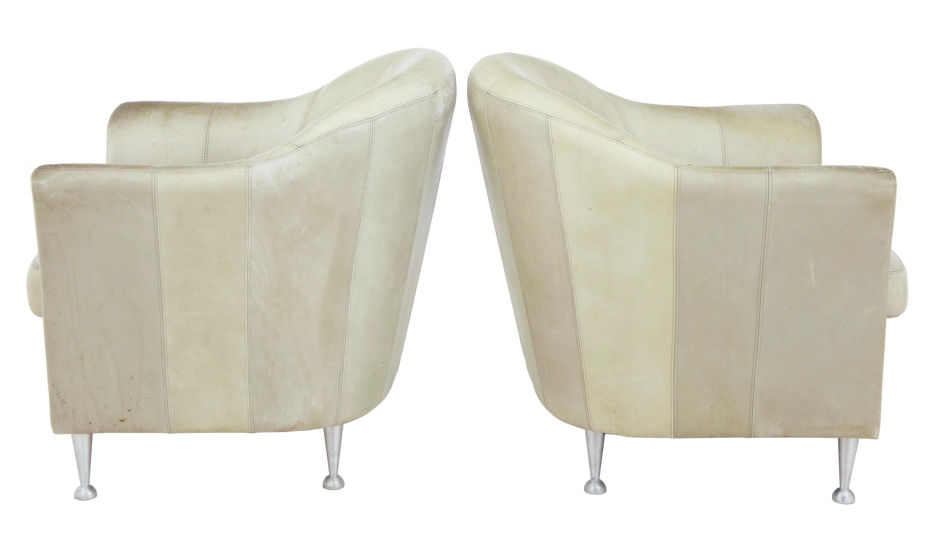 Pair of mid-20th century Scandinavian leather tub armchairs, circa 1960.

Very comfortable pair of lounge chairs. Wear and staining to leather but no holes. A deep clean and leather re-coloring would make these a fine pair of chairs. Standing on