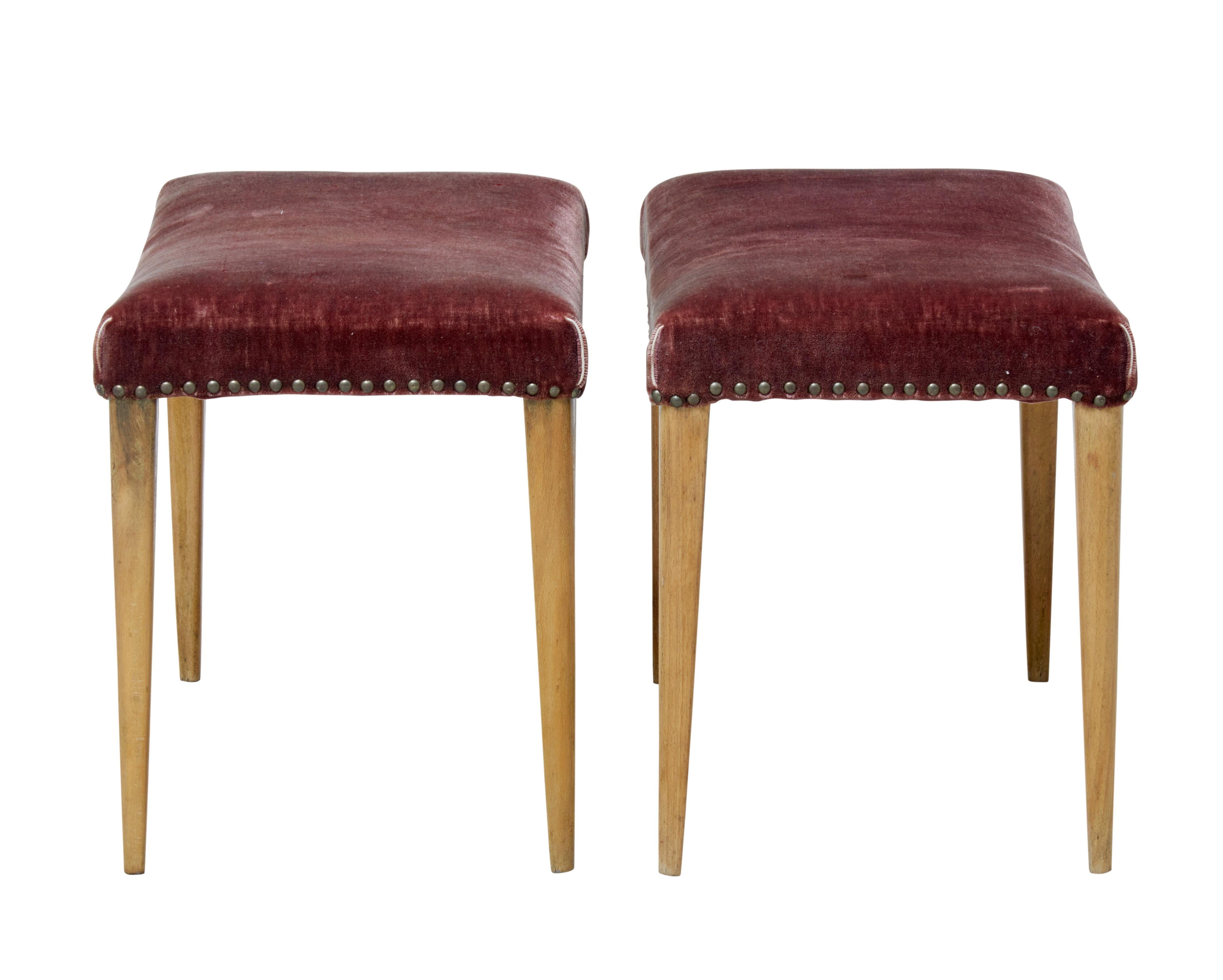 Pair of mid-20th century Scandinavian oak stools, circa 1950.

Pair of Scandinavian Modern designed stools that offer great potential.

Shaped seat covered in velvet with stud work. Standing on tapering oak legs.

Covering is usable albeit now