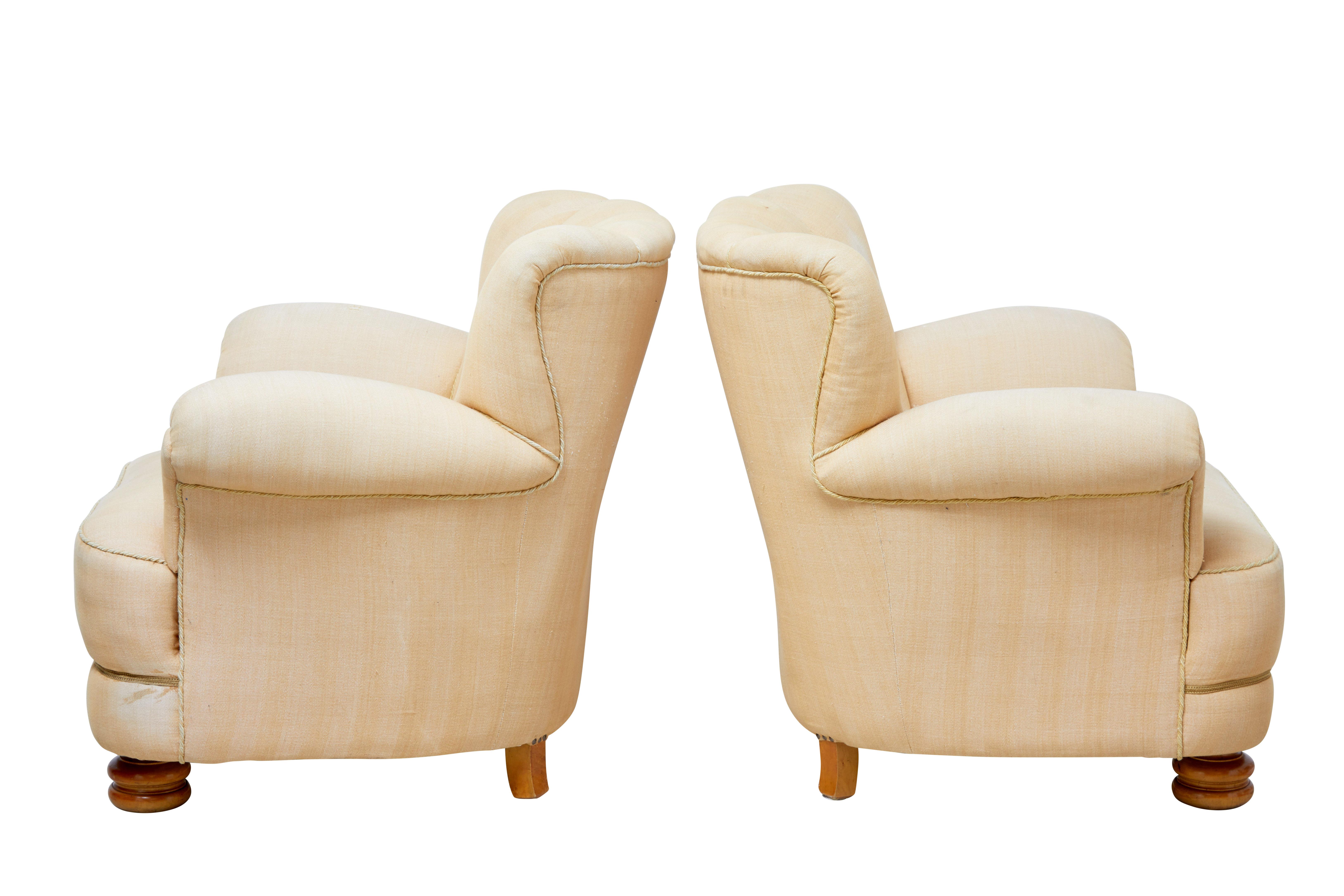 Pair of 1960s Scandinavian armchairs in the Art Deco taste.

Very comfortable pair of large armchairs, very much of Art Deco design.

Shaped shell backs with buttons and piping, roll top arms. A good deep and wide seat giving great
