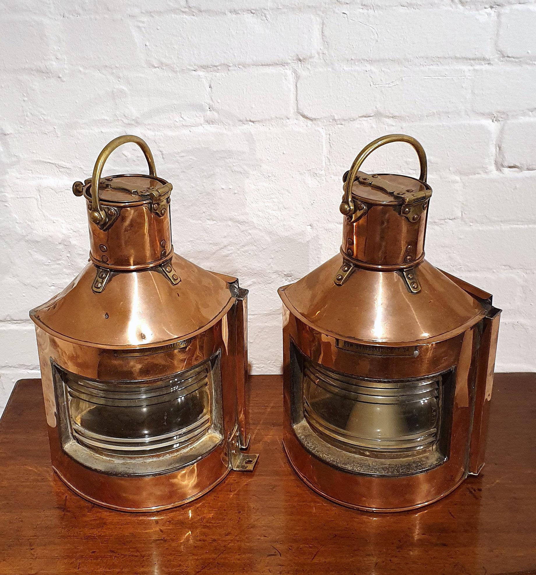 This very attractive and decorative pair of mid-20th century. Copper ship lanterns are dated 1944, which historically, is significant as it was during World War II. They are both marked Bow Starboard Patt. 24, and feature brass hardware and accent