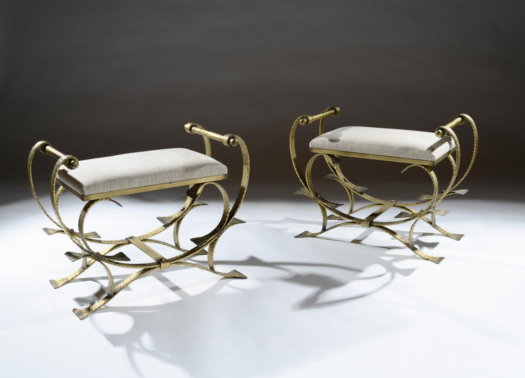 A unusual pair of Mid-Century Modern Spanish gilt metal and linen upholstered stools / window seats.

Spanish, circa 1950.

Very stylish, having ornate contemporary scroll work gilt iron frames and newly linen upholstered seats. These decorative