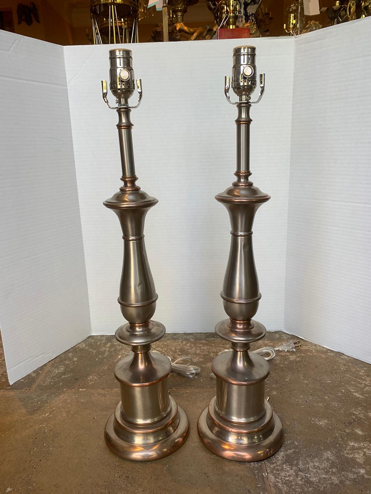 Pair of mid-20th century steel and brass lamps
New wiring.
