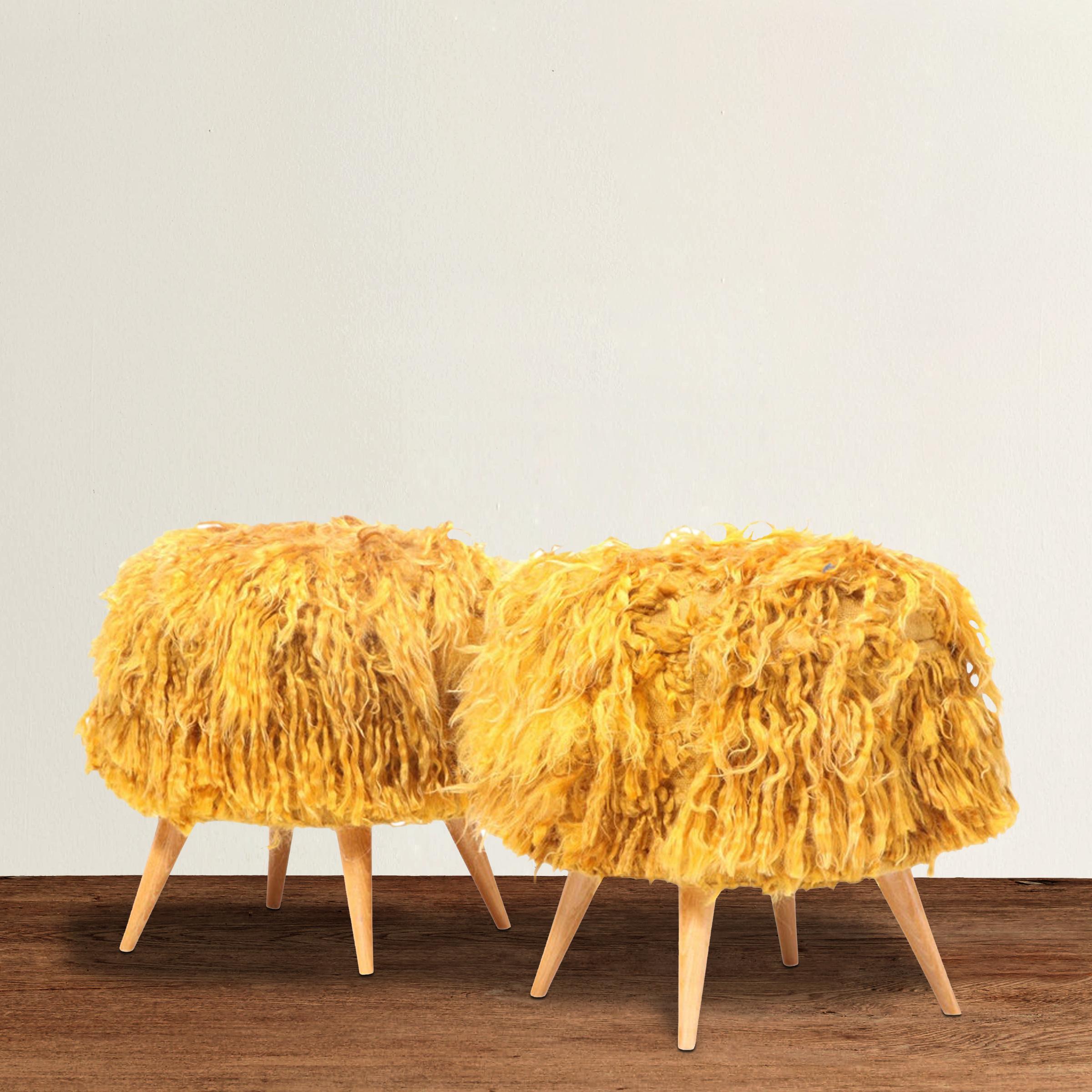 A pair of mid-20th century American stools with turned beech legs, and upholstered in shaggy vintage Turkish goldenrod Angora Tulu rugs.