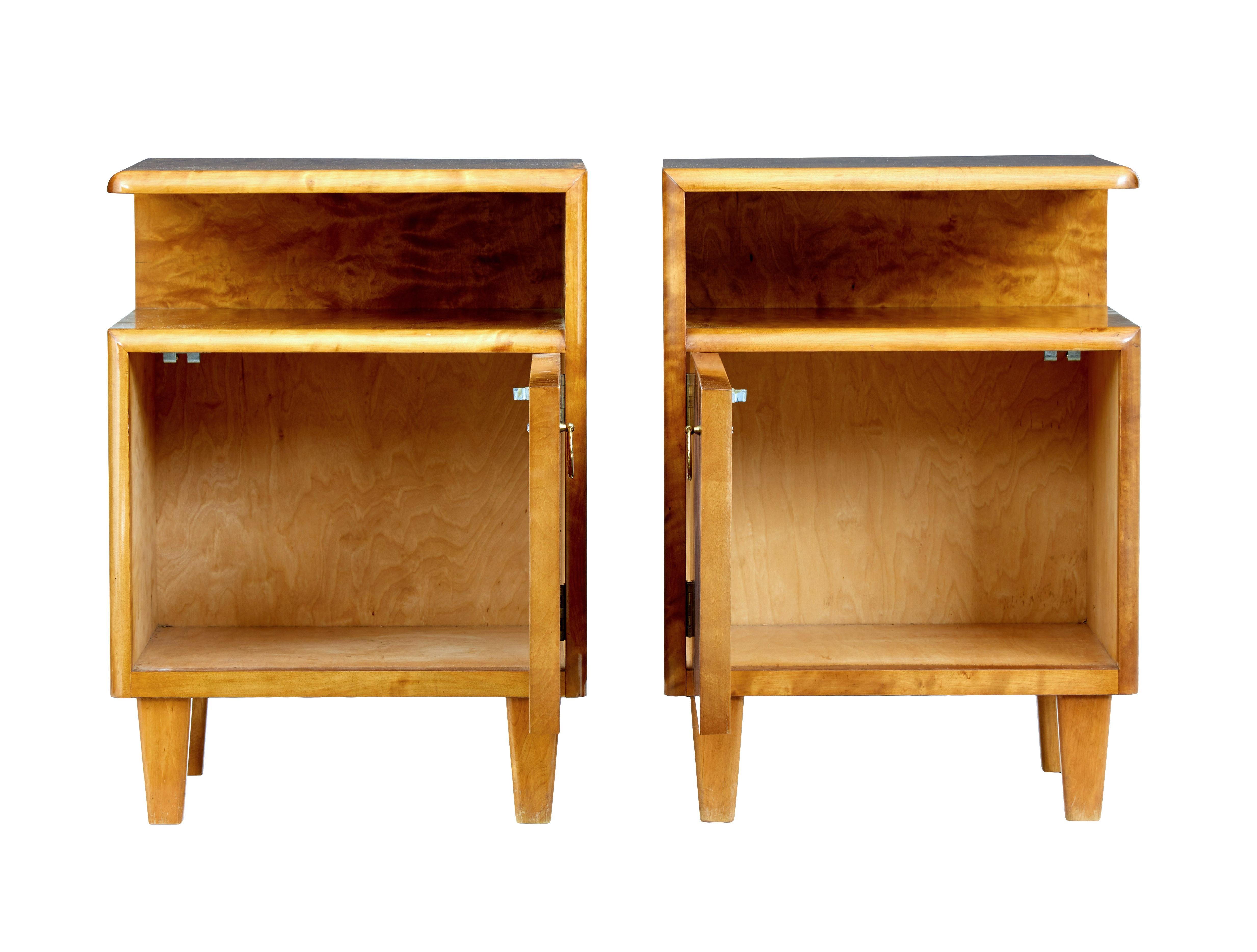 Good quality pair of Scandinavian design bedside tables, circa 1950.

Model know as 'Sonja' and produced by Mobel AB Altorp.

Floating top surface with storage space below. Single door cupboard with brass ring handle.

Some surface marks to 1