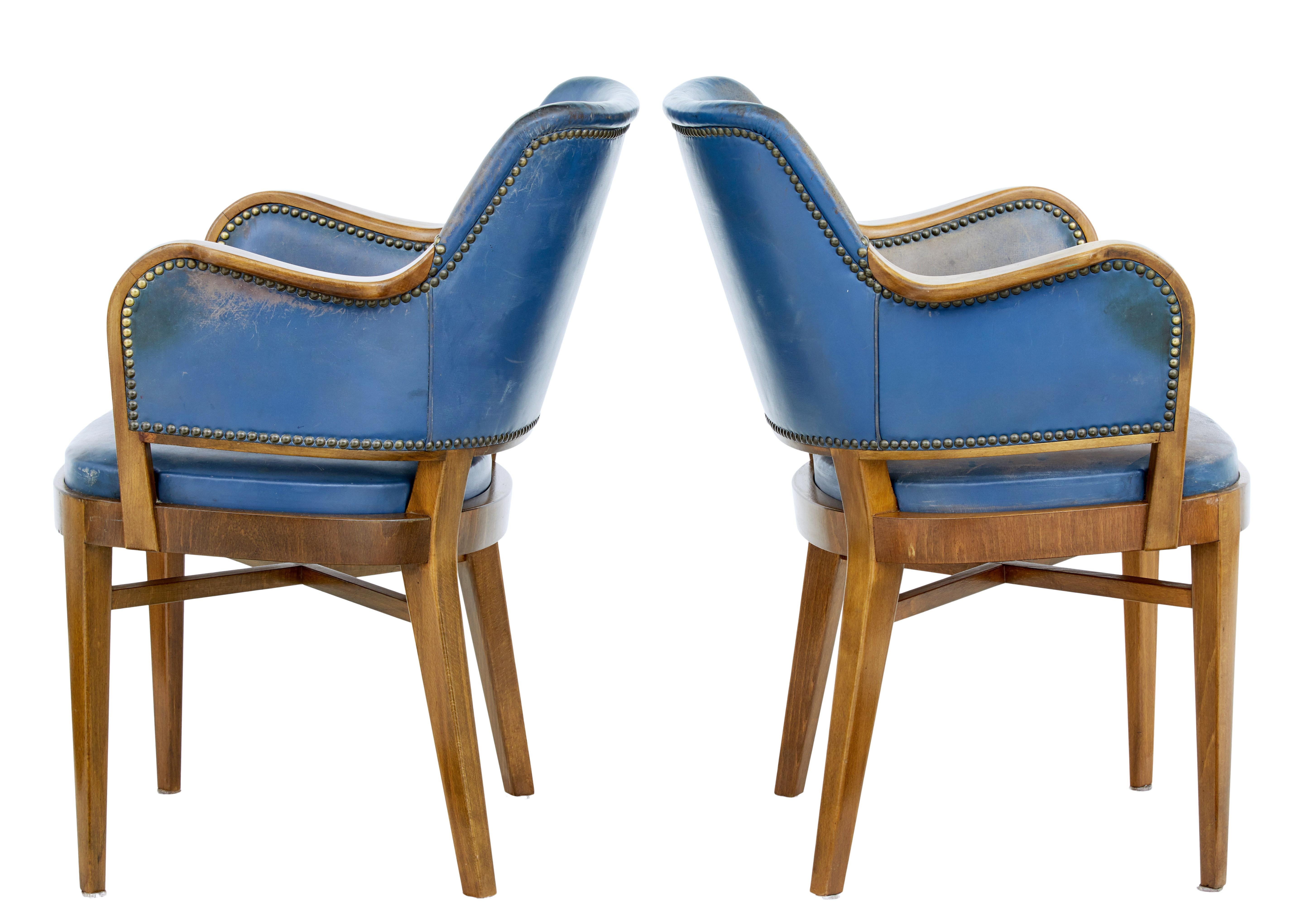 Pair of mid-20th century teak and leather armchairs circa 1950.

Very comfortable pair of Scandinavian armchairs. Shaped backs and made from teak that has been coloured to match walnut. Show frame arms and original leather covering and stud work