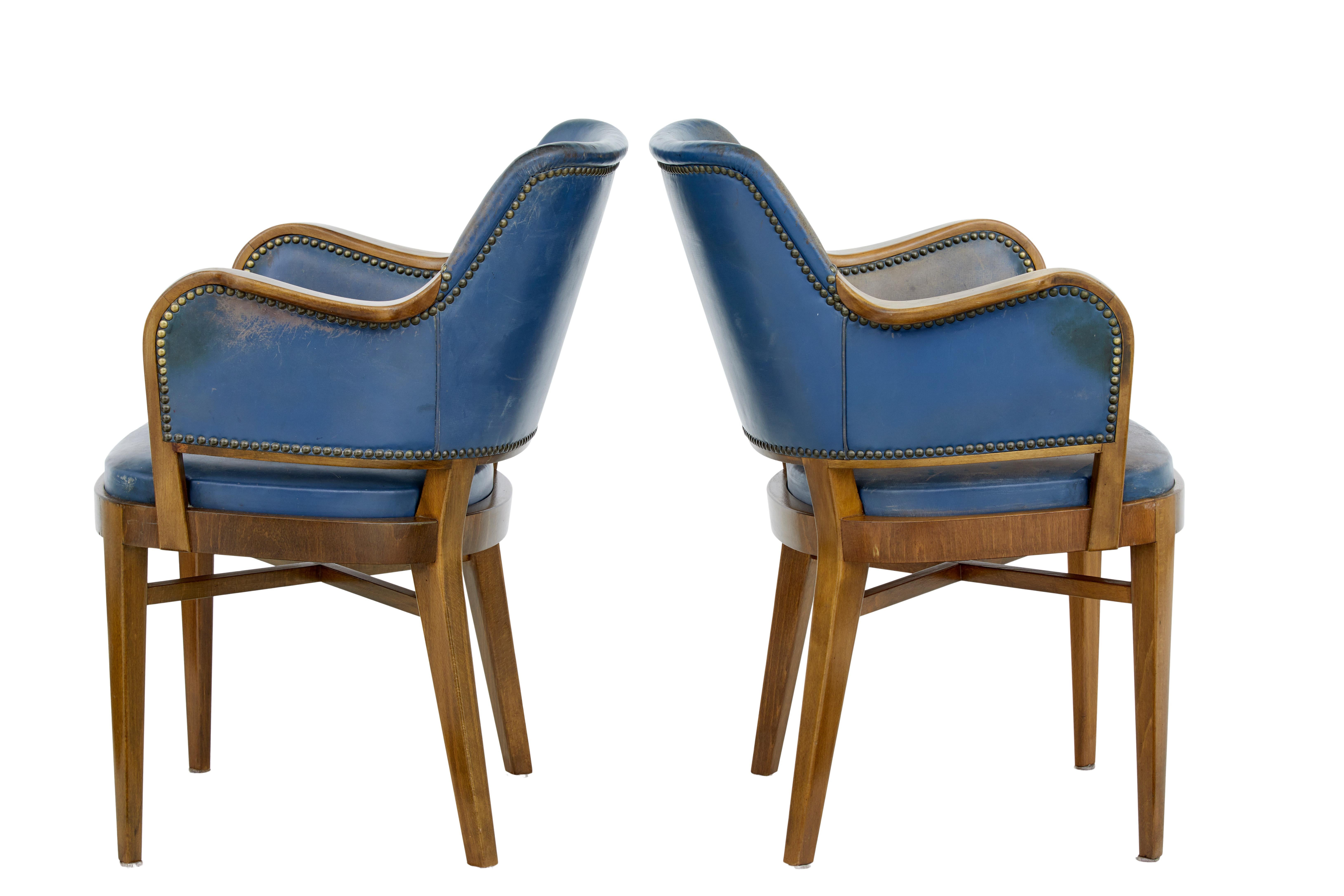 Pair of mid-20th century teak and leather armchairs, circa 1950.

Very comfortable pair of scandinavian armchairs. Shaped backs and made from teak that has been colored to match walnut. Showframe arms and original leather covering and studwork