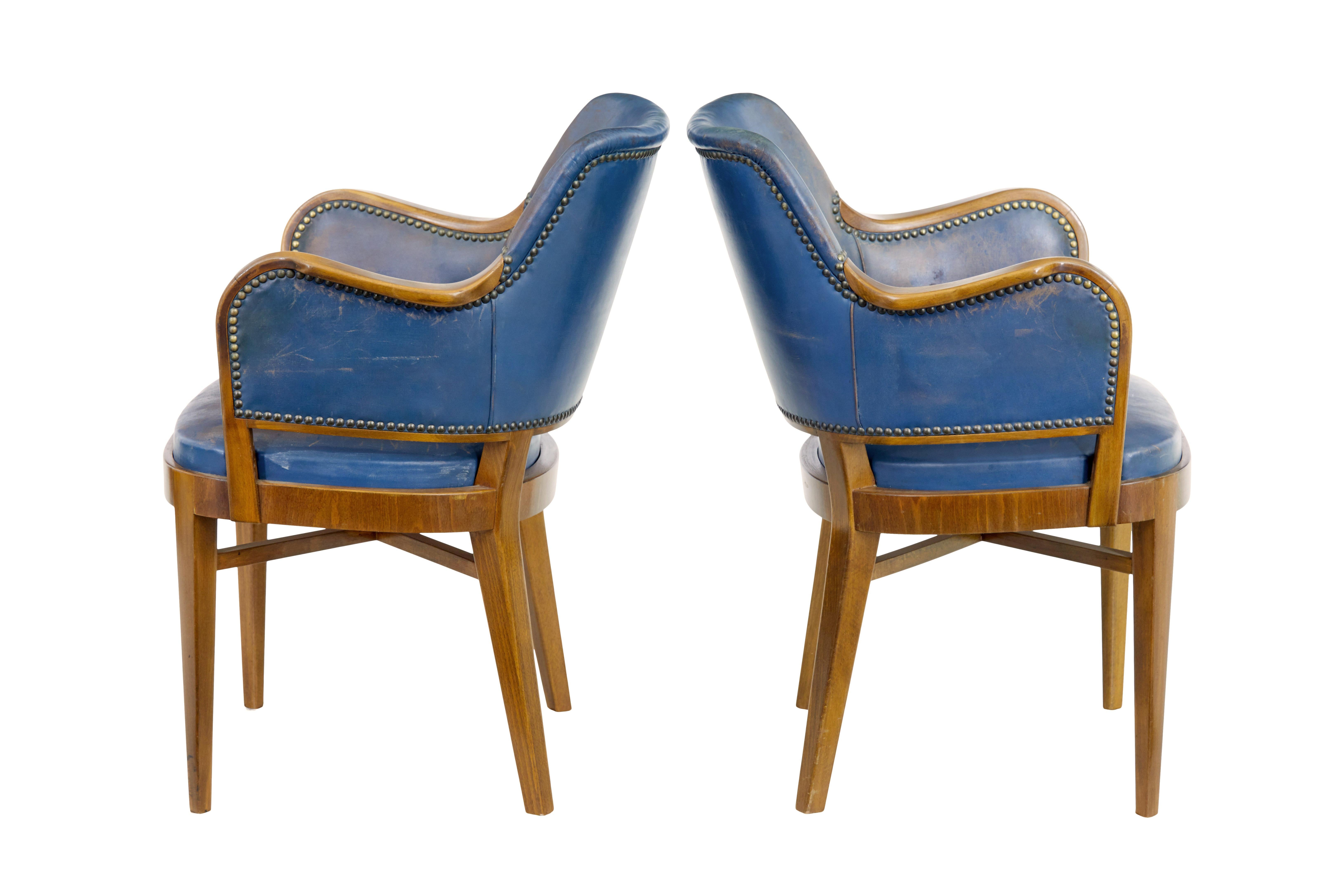 Pair of mid 20th century teak and leather armchairs circa 1950.

Very comfortable pair of Scandinavian armchairs. Shaped backs and made from teak that has been coloured to match walnut.  Show frame arms and original leather covering and studwork